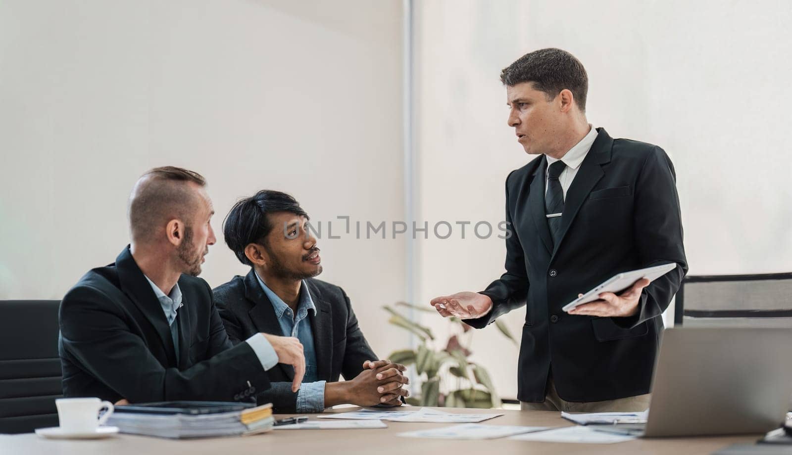 Business People Meeting using laptop computer,calculator,notebook,stock market chart paper for analysis Plans to improve quality next month. Conference Discussion Corporate Concept.