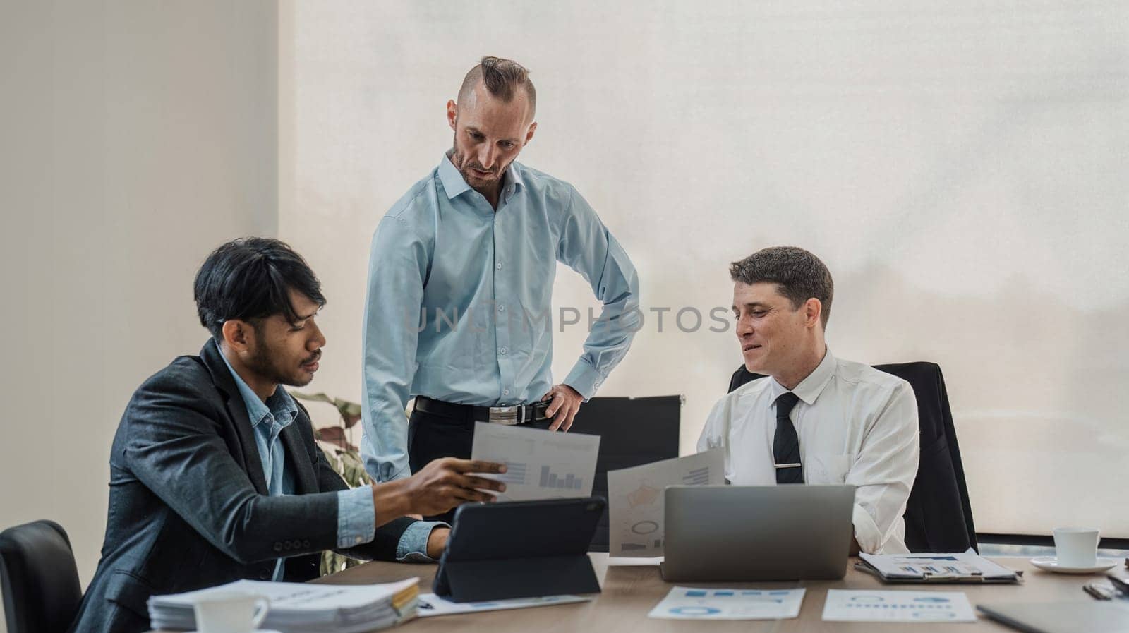 Business People Meeting using laptop computer,calculator,notebook,stock market chart paper for analysis Plans to improve quality next month. Conference Discussion Corporate Concept.