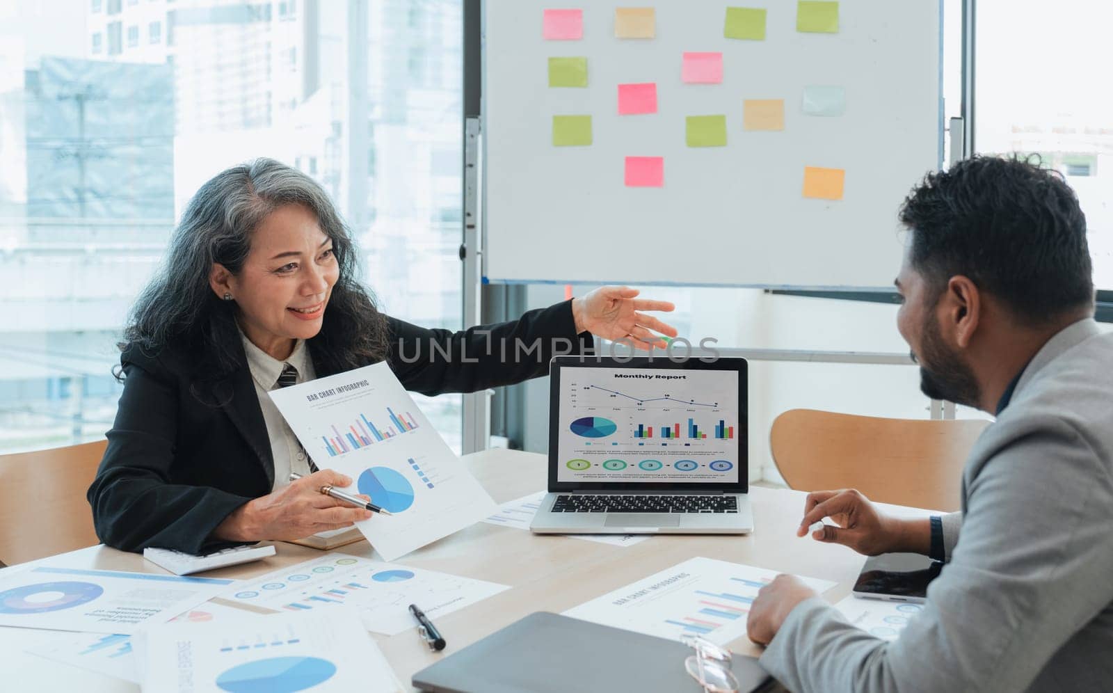 Business People Meeting using laptop computer,calculator,notebook,stock market chart paper for analysis Plans to improve quality next month. Conference Discussion Corporate Concept.