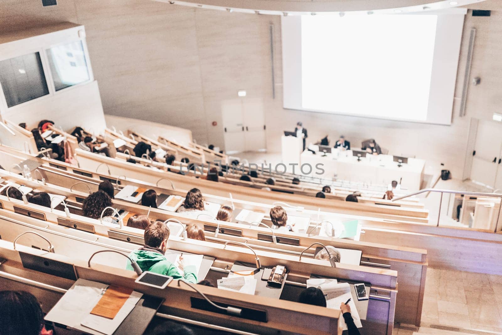 Conference and Presentation. Audience at the conference hall. Business and Entrepreneurship. Faculty lecture and workshop. Audience in the lecture hall. Academic education. Student making notes.