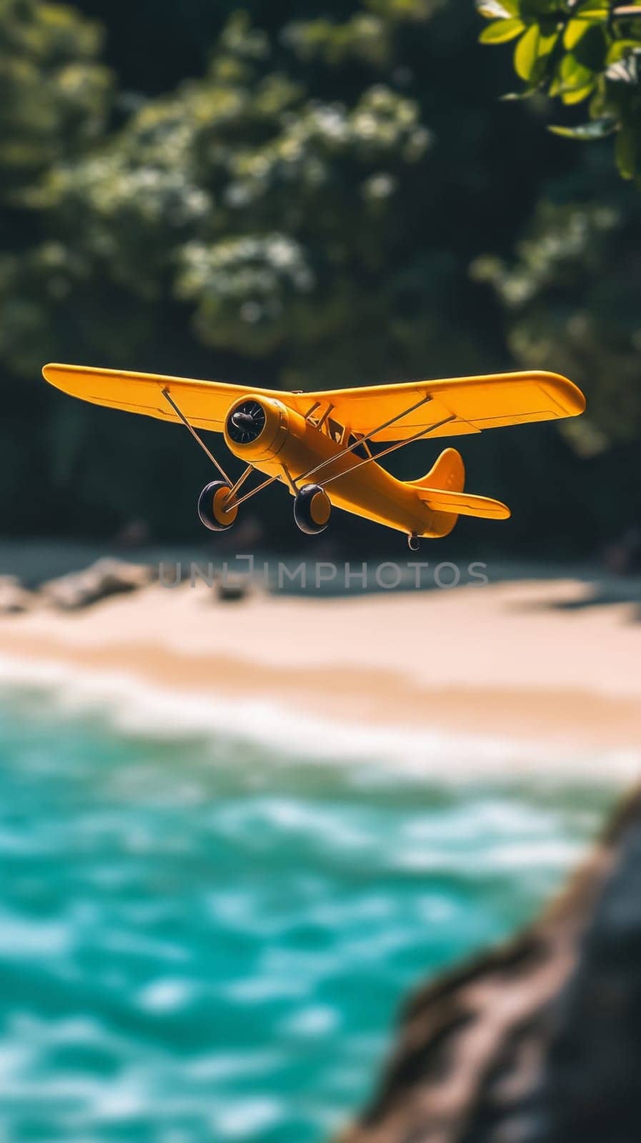 Yellow vintage airplane flying over tropical beach, daytime. Adventure and travel concept.