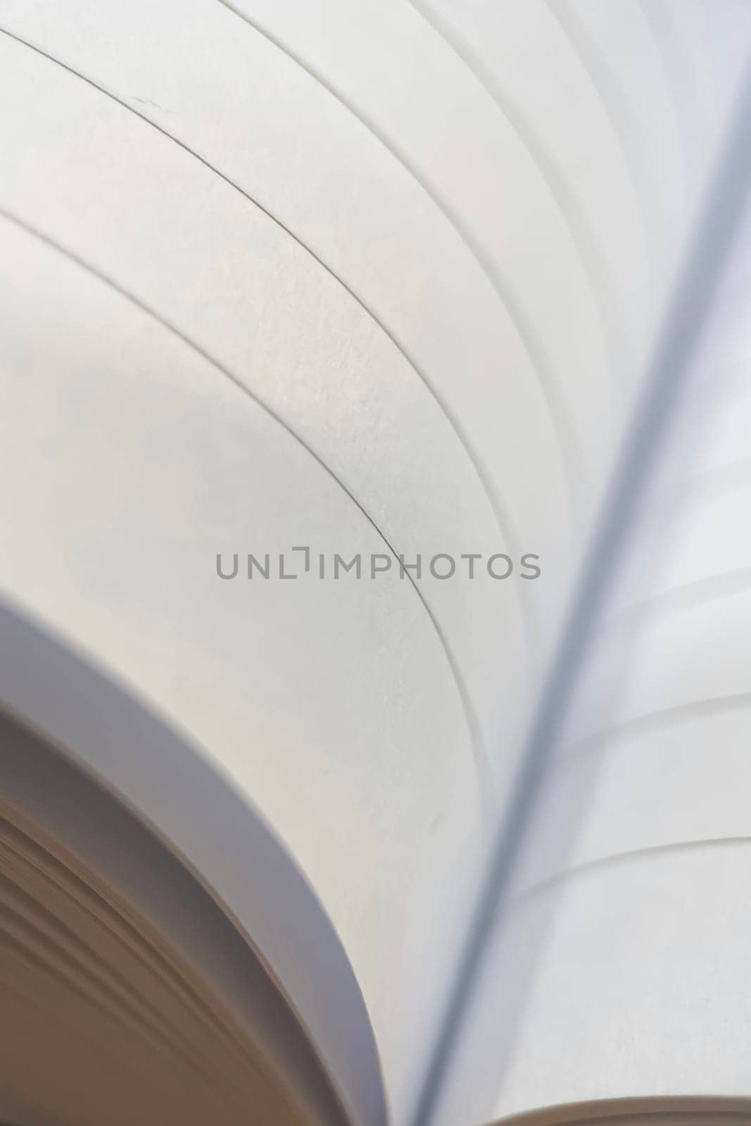 A close-up of notebook pages forming a soft, wavy pattern. A useful image for themes of education, knowledge, and simplicity.