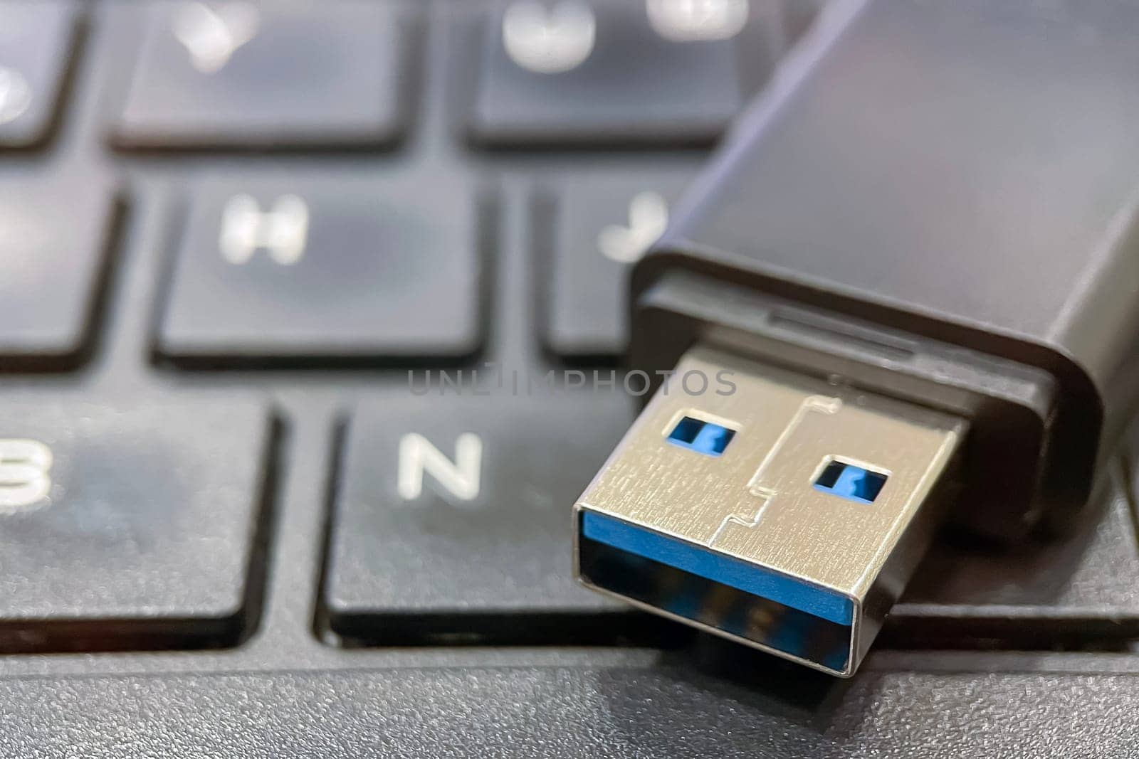 USB 3.0 Flash Drive Close-up. Metal connector and black case details of a USB 3.0 flash drive. This image is perfect for explaining data transfer, portable storage solutions and modern technology concepts.