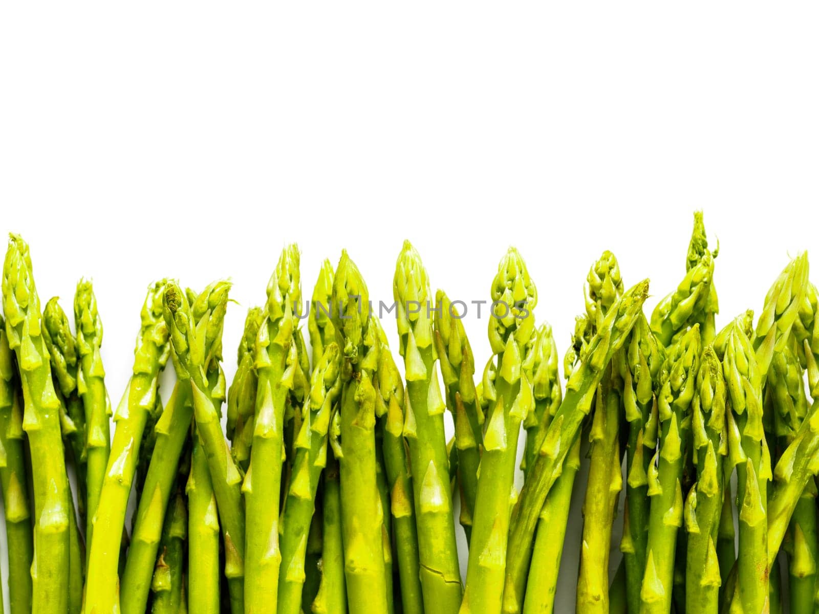 Fresh green asparagus isolated on white. Asparagus food background isolated one side. Top view or flat lay. Copy space.