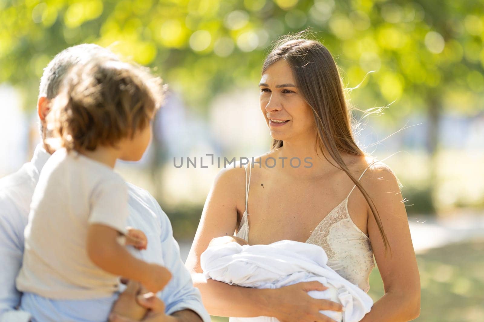 Young family is spending time together in the park on a sunny summer day