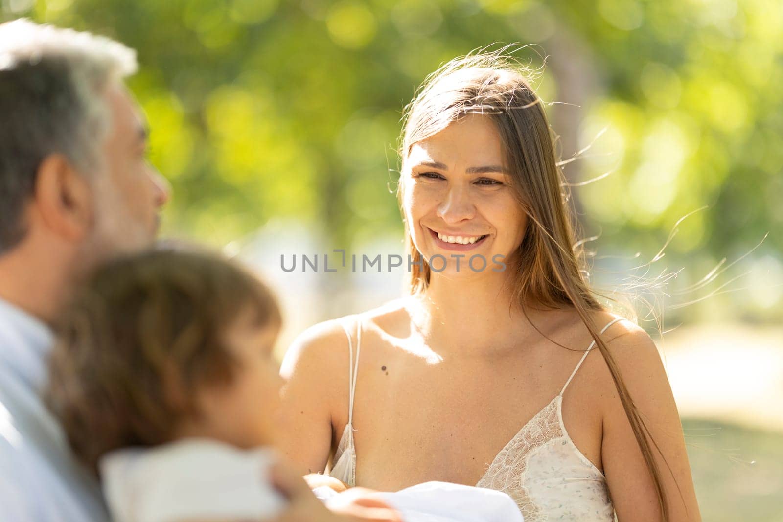 Happy family is spending time together in the park on a sunny summer day