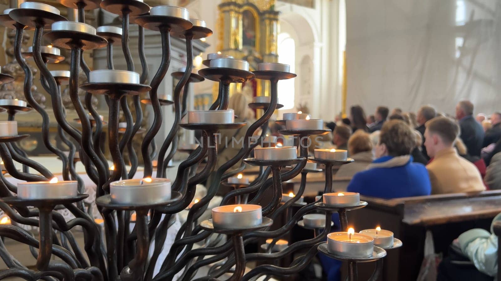 Burning candles in a Catholic church during the Divine Service