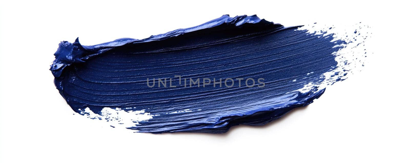 Bold indigo paint brush stroke texture on white background for art and design projects.