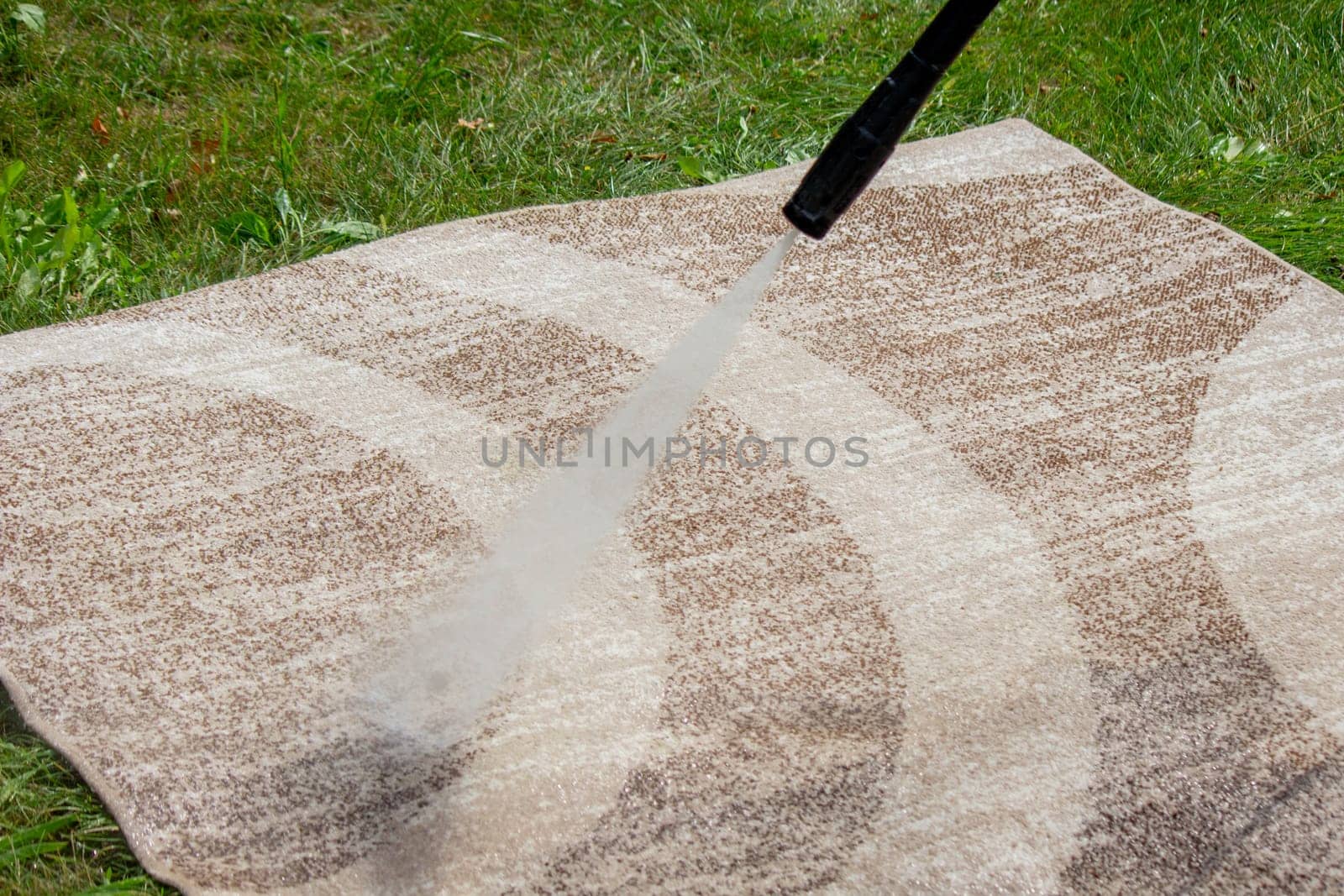 washing the carpet with a high pressure washer. Selective focus.
