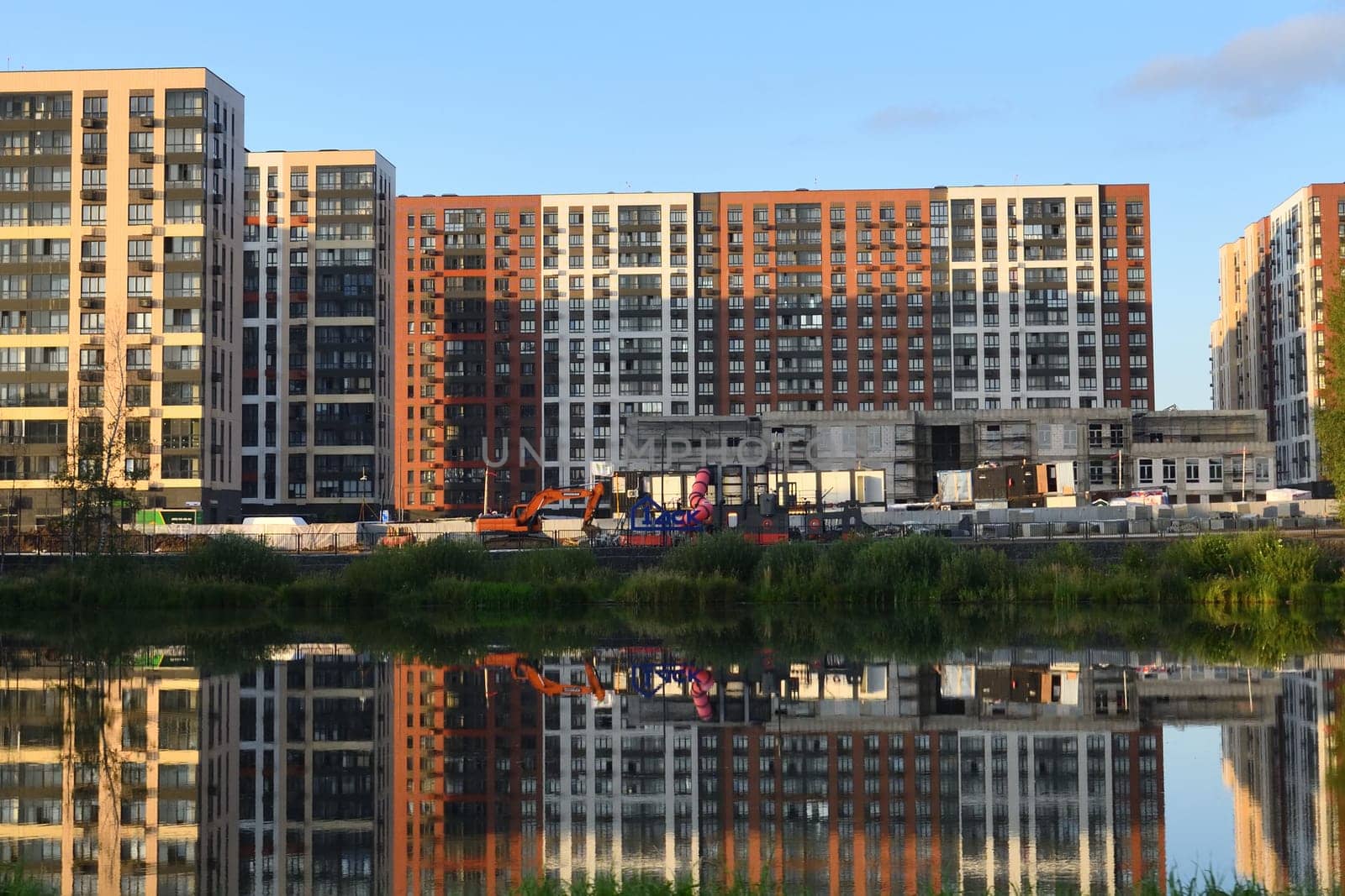 Moscow, Russia - Aug 3. 2024. Residential complex 1 Leningradsky and the Molzhaninovsky pond