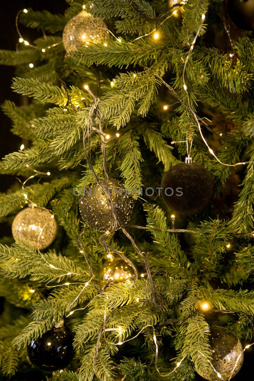 Balls on the Christmas tree close-up. Christmas tree design decorations. The concept of celebrating New Year and Christmas