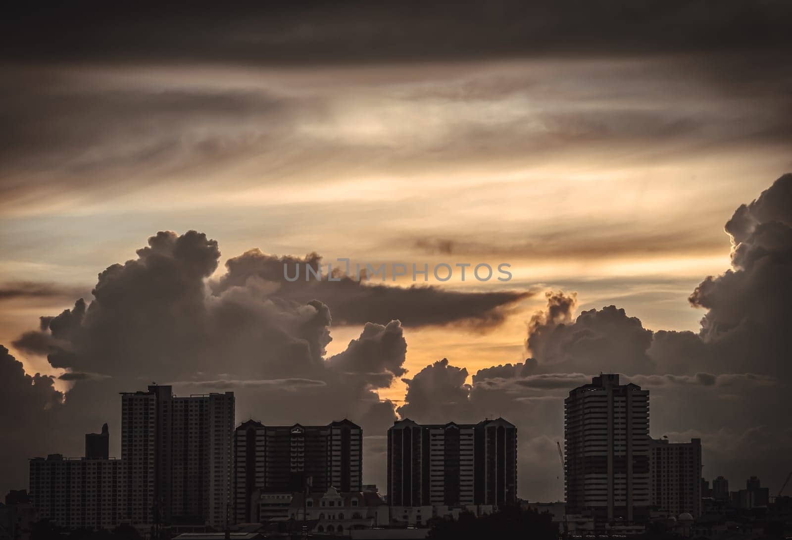 Bangkok, Thailand - 22 Aug, 2024 - Silhouette view of Modern high-rise buildings and background of Dramatic sky in the city of Bangkok. Picturesque view of skyscrapers before Sunset. use it as your Wallpaper, Poster and Space for text, Selective focus.