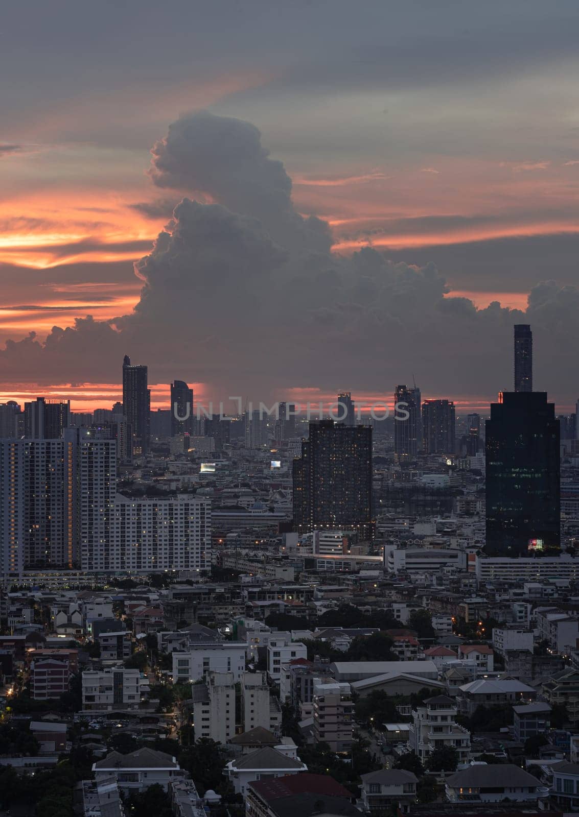 Bangkok, Thailand - 23 Aug 2024 - View of Beautiful Clouds in the Sky over Large Metropolitan City. Bangkok city skyscrapers after sunset with Dramatic sky background before Sunset, Space for text, Selective focus.