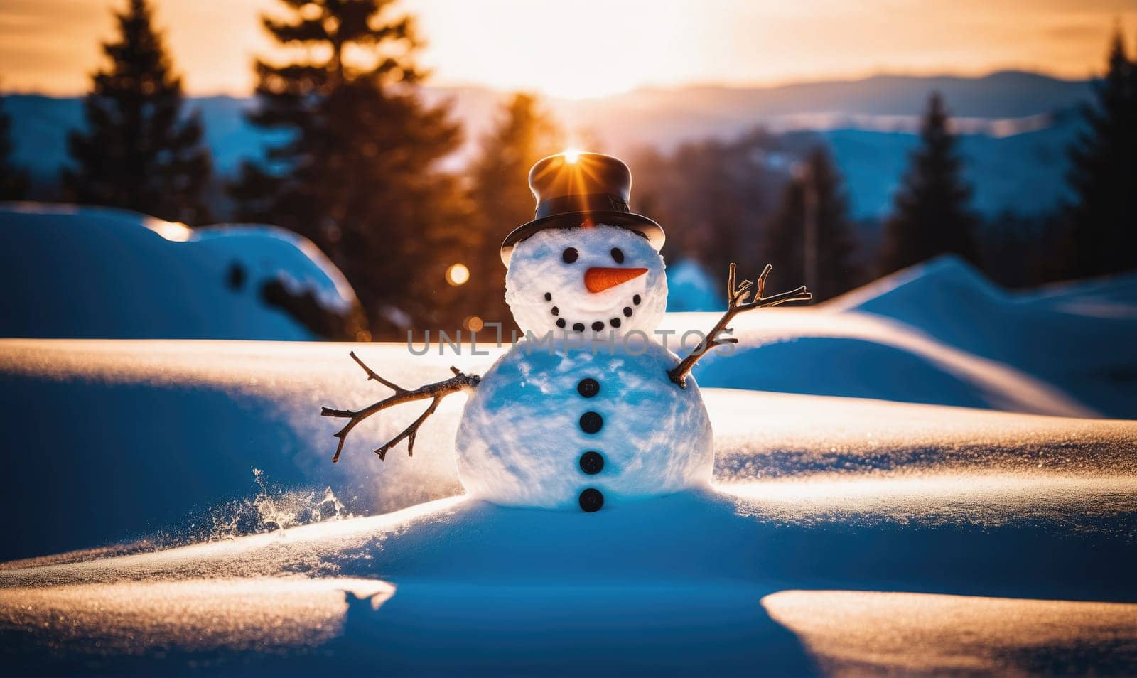 A snowman with a black hat and stick arms smiles at the viewer. The snowman is built in a snowy field and the sun is setting behind the snowy trees.