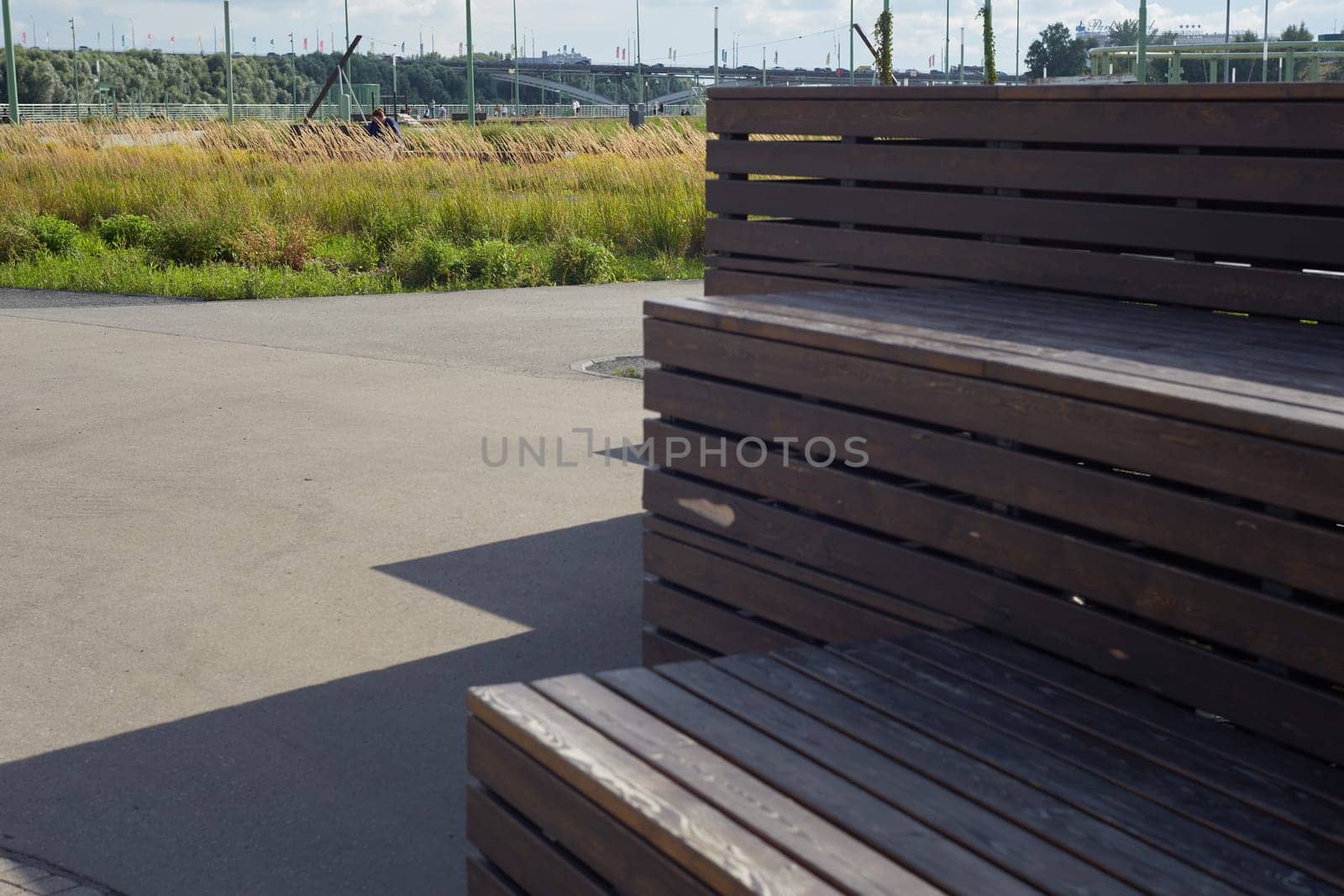 Wooden benches for sitting .An outdoor area of the park where visitors can relax and admire nature