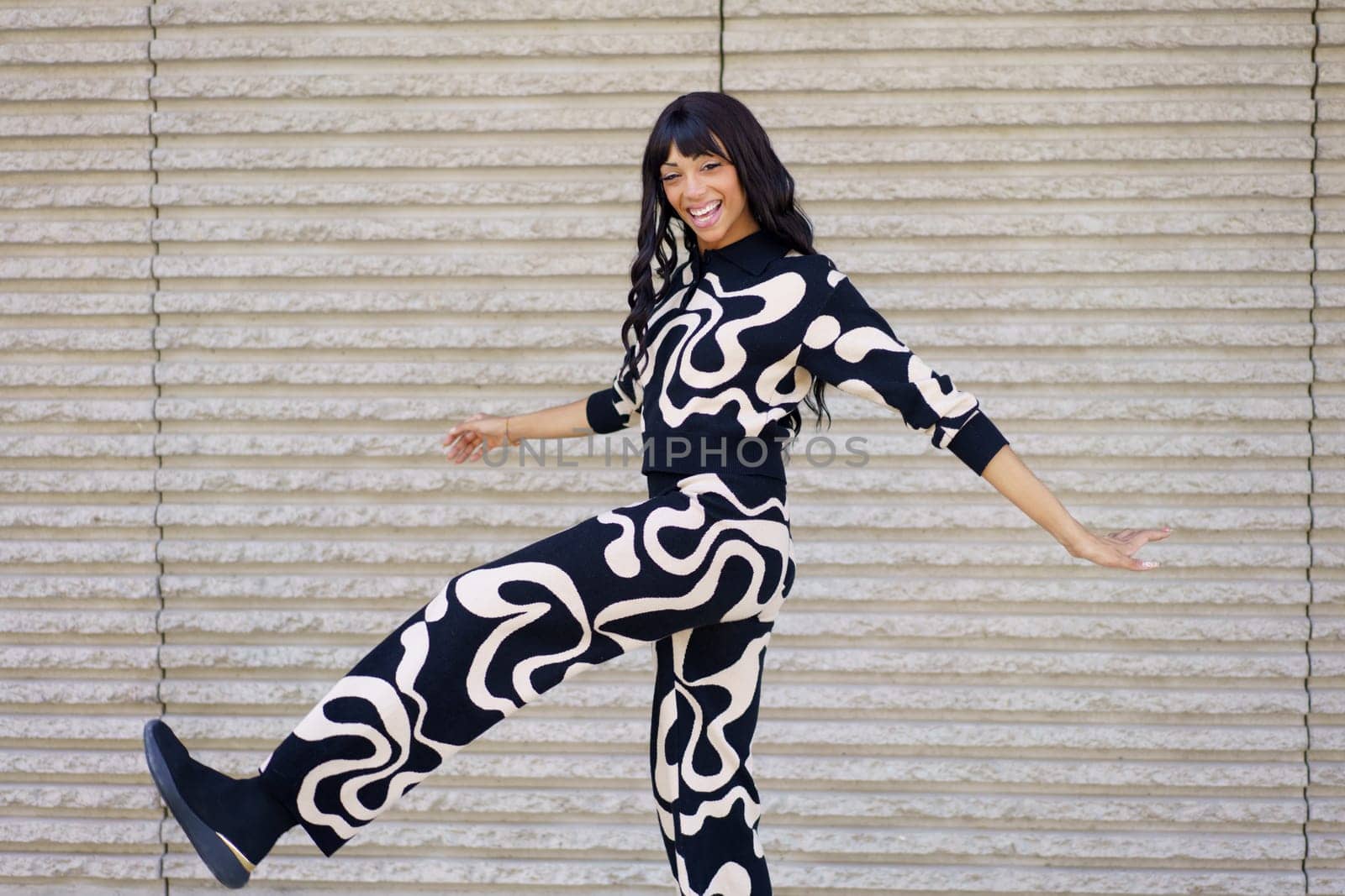 Energetic hispanic beauty female dancer performing a choreography in the city