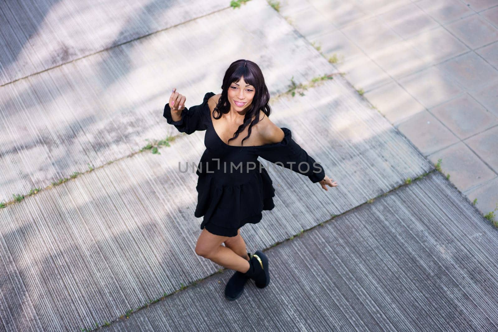 Top view of a cool dancer performing in the street in summer