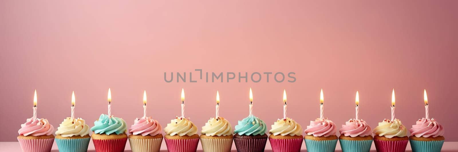 Colorful cupcakes with lit candles are displayed against a pink background, indicating an indoor celebration event marking of joy and celebrating. with free space.