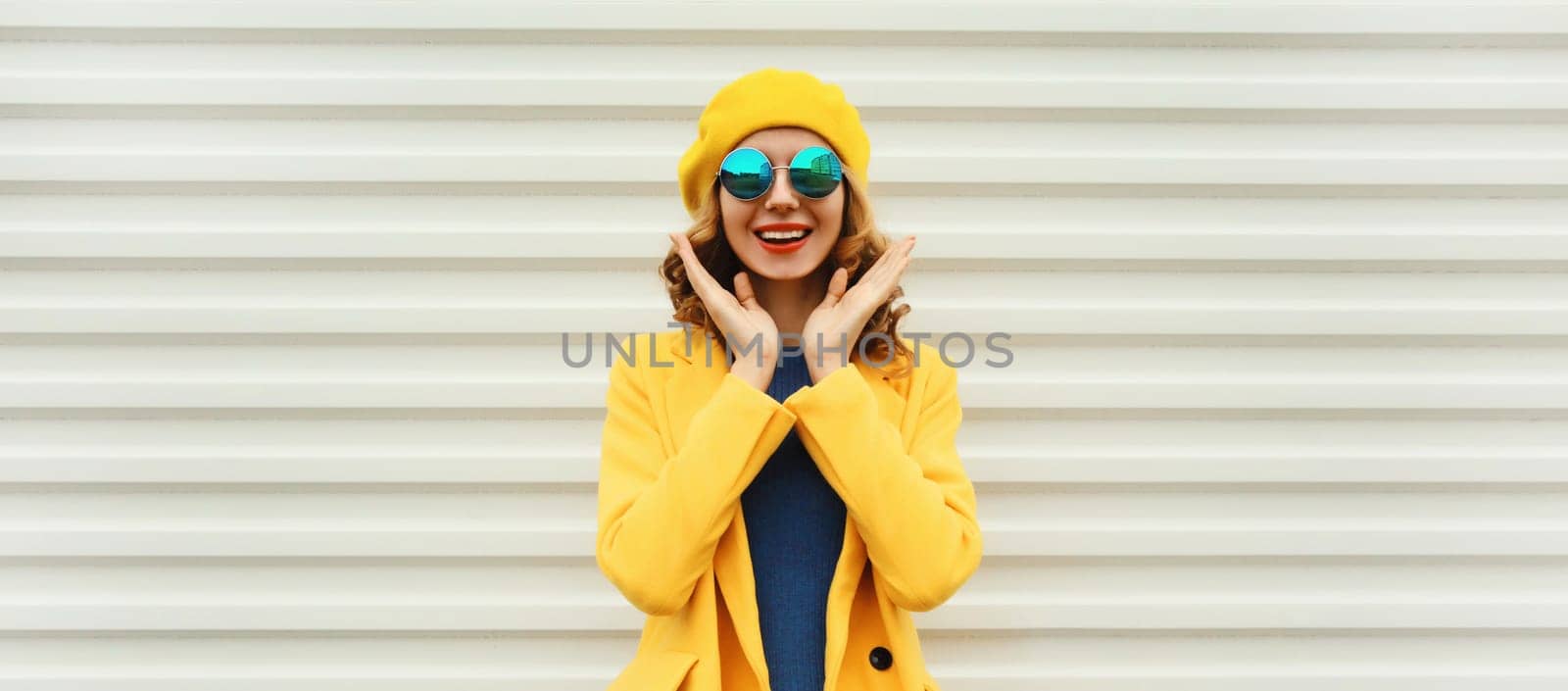 Autumn portrait of beautiful happy laughing surprised woman in yellow french beret hat, stylish girl posing on white background