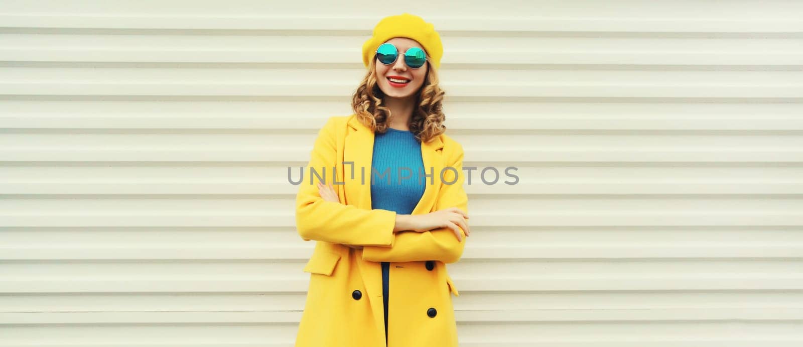 Autumn portrait of beautiful happy smiling woman in yellow french beret hat, stylish trendy girl posing on white background