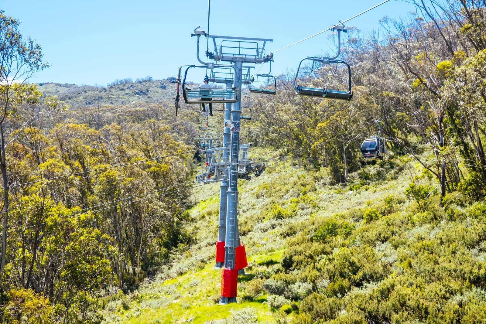 THREDBO, AUSTRALIA - DECEMBER 15 2023: Chairlifts for mountain biking summer season at Thredbo on a warm summer's day in the Snowy Mountains, New South Wales, Australia