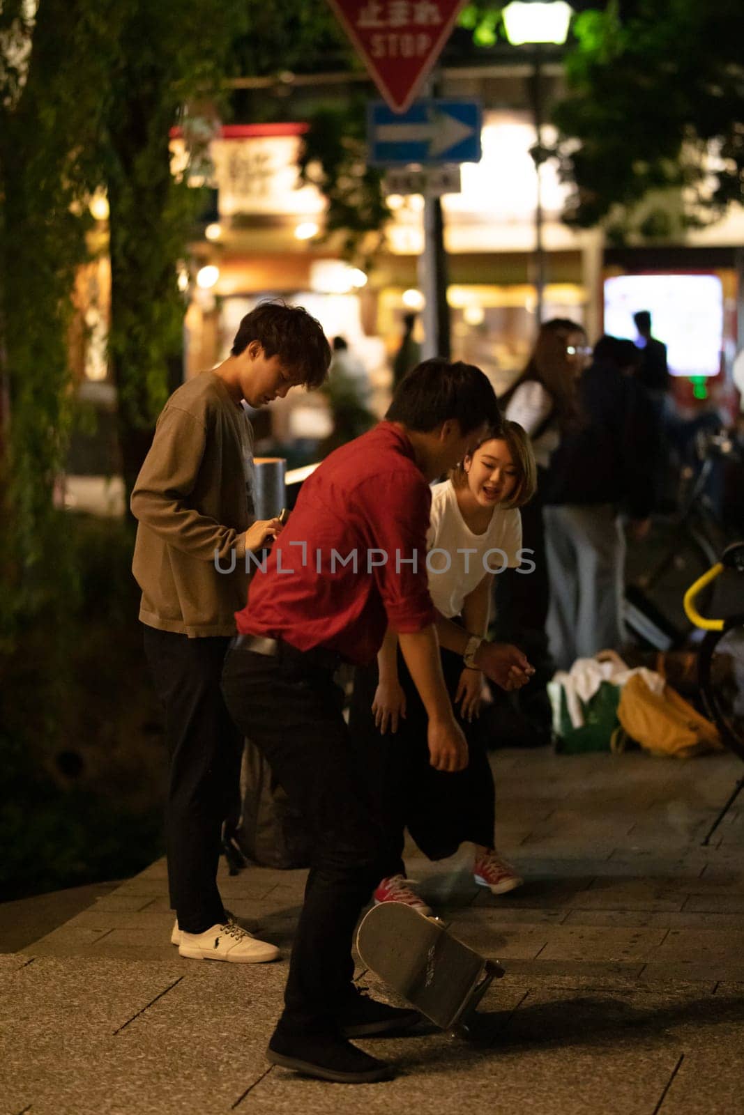 KYOTO, JAPAN - MAY 18: Local kids skateboard on the streets at night in Kyoto, Japan