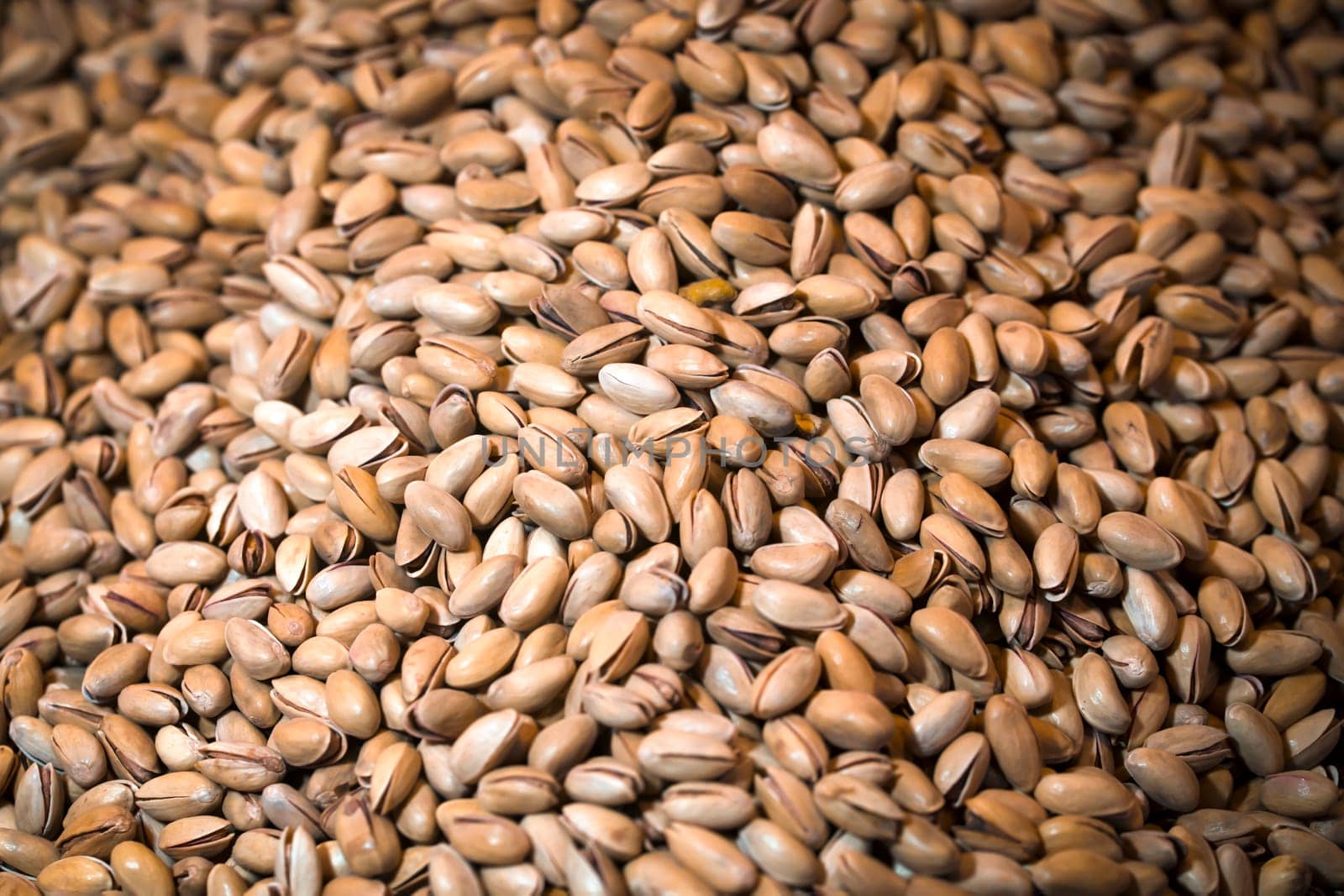 Pistachios in the shell, a lot of useful nuts lie and are prepared for eating, for creating a product.
