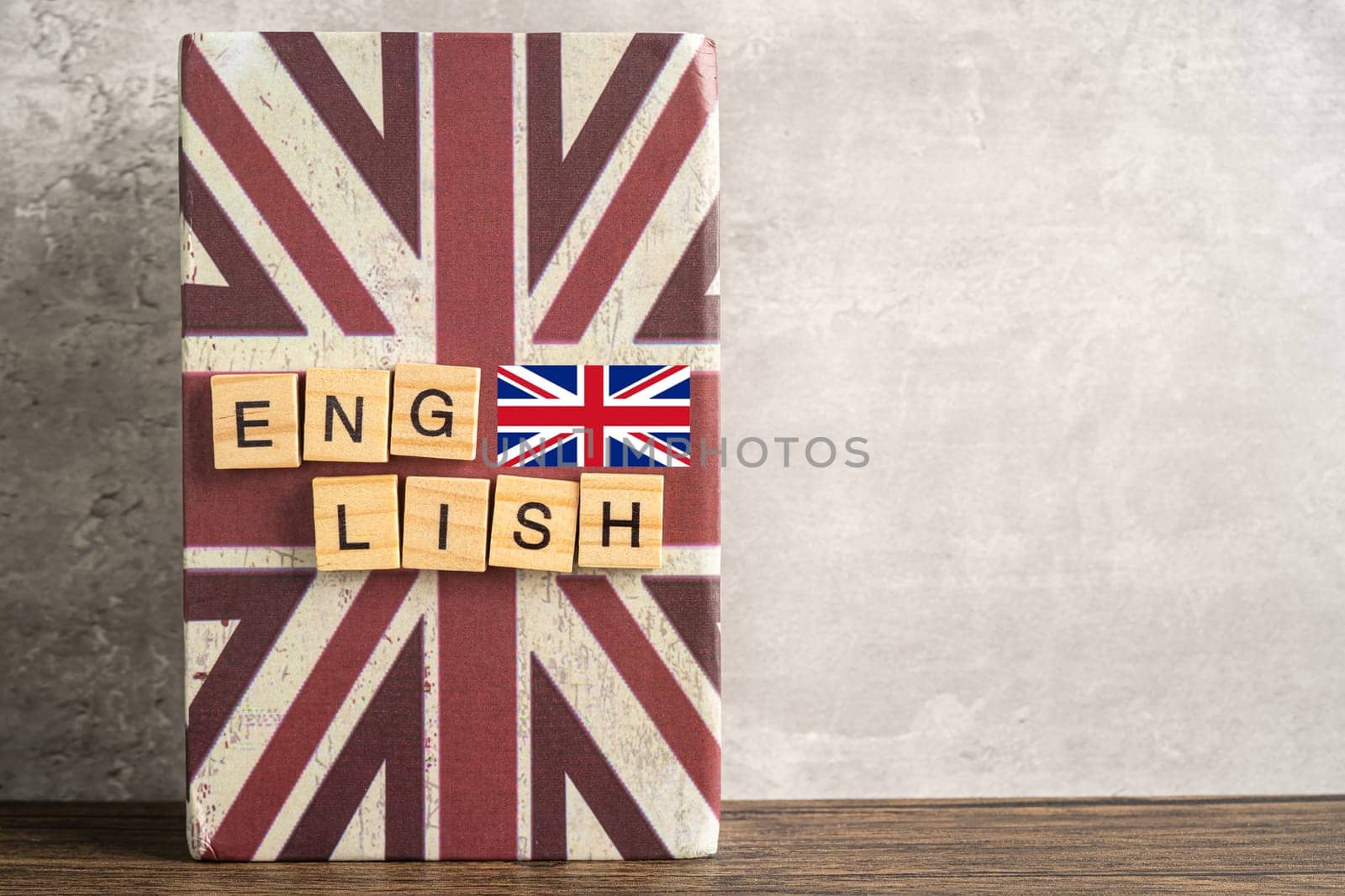 Word English on book with United Kingdom flag, learning English language courses concept. by pamai