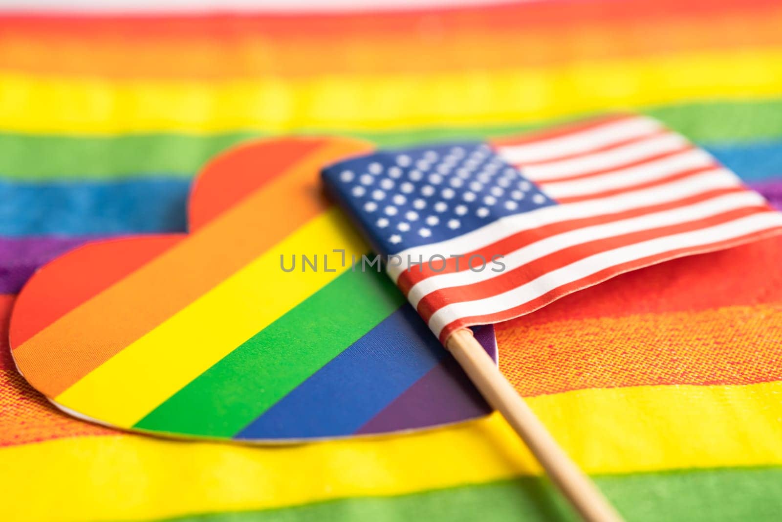 USA America flag on rainbow background flag symbol of LGBT gay pride month  social movement rainbow flag is a symbol of lesbian, gay, bisexual, transgender, human rights, tolerance and peace.