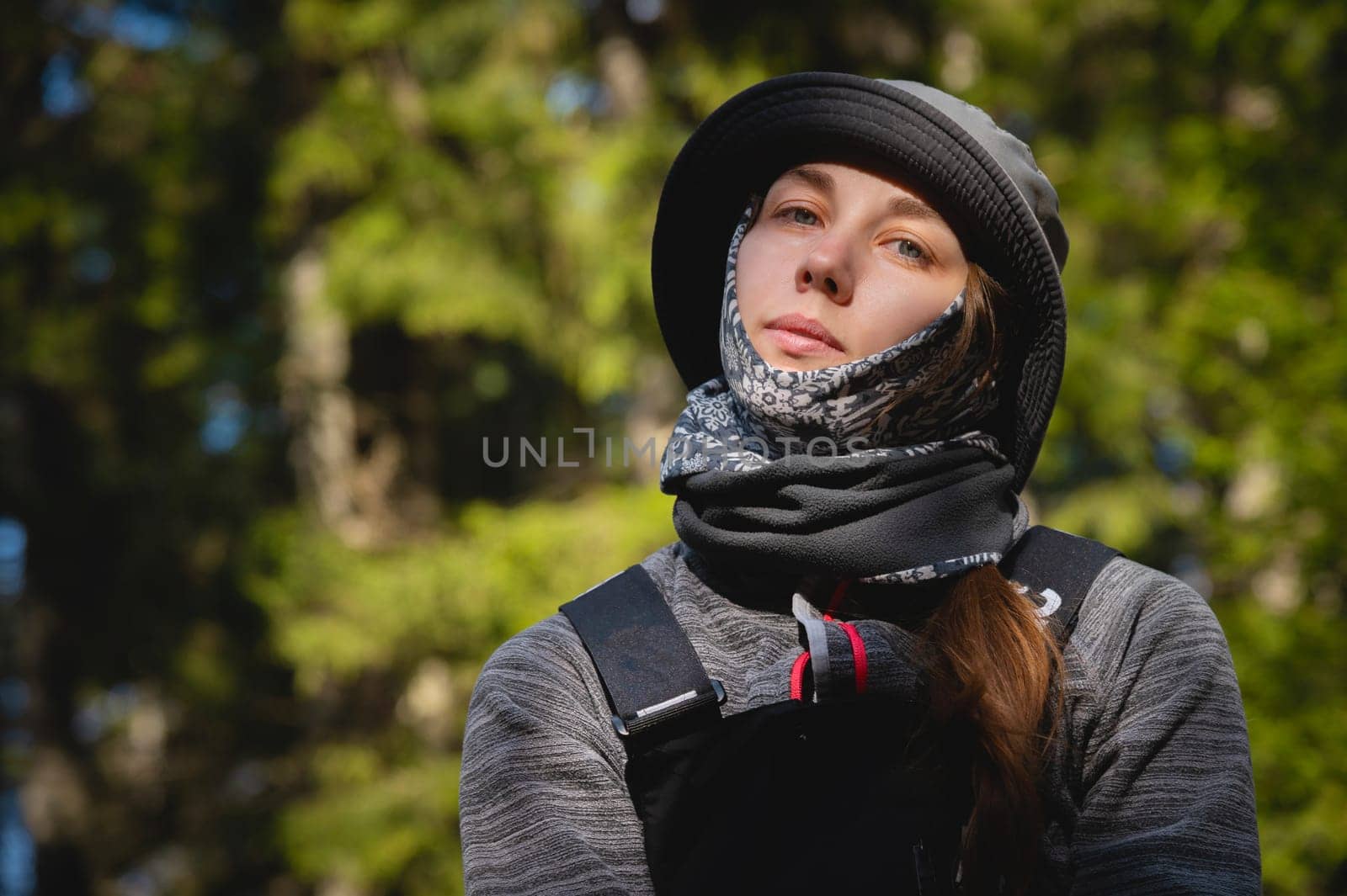 Portrait of a young woman traveler. Fresh and healthy lifestyle. Caucasian beautiful tourist woman traveling alone in wild forest.