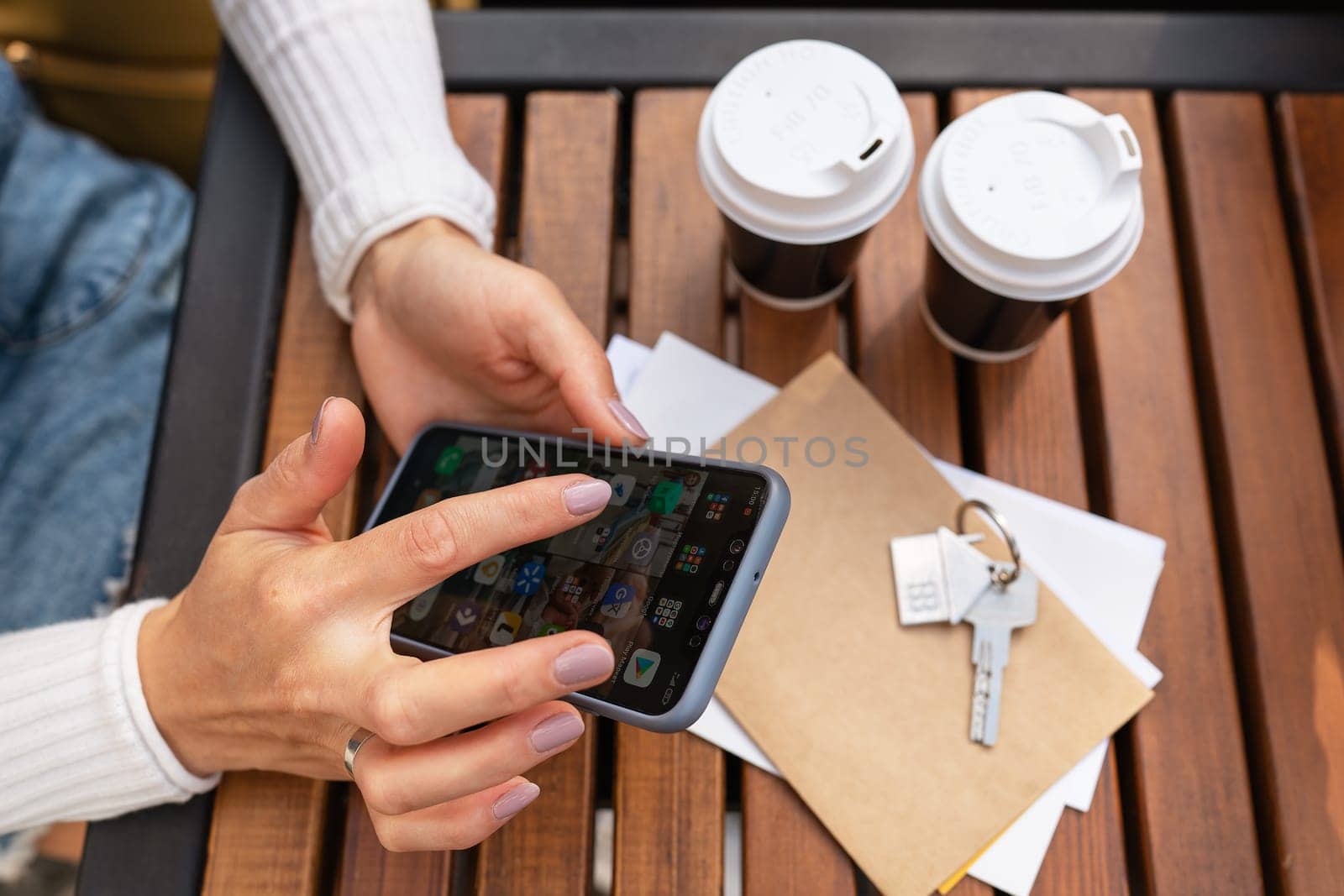 Coffee break, girl on the phone. Real estate, keys from the tenant from an apartment or house, purchase and sale of real estate. Mortgage for the purchase of an apartment