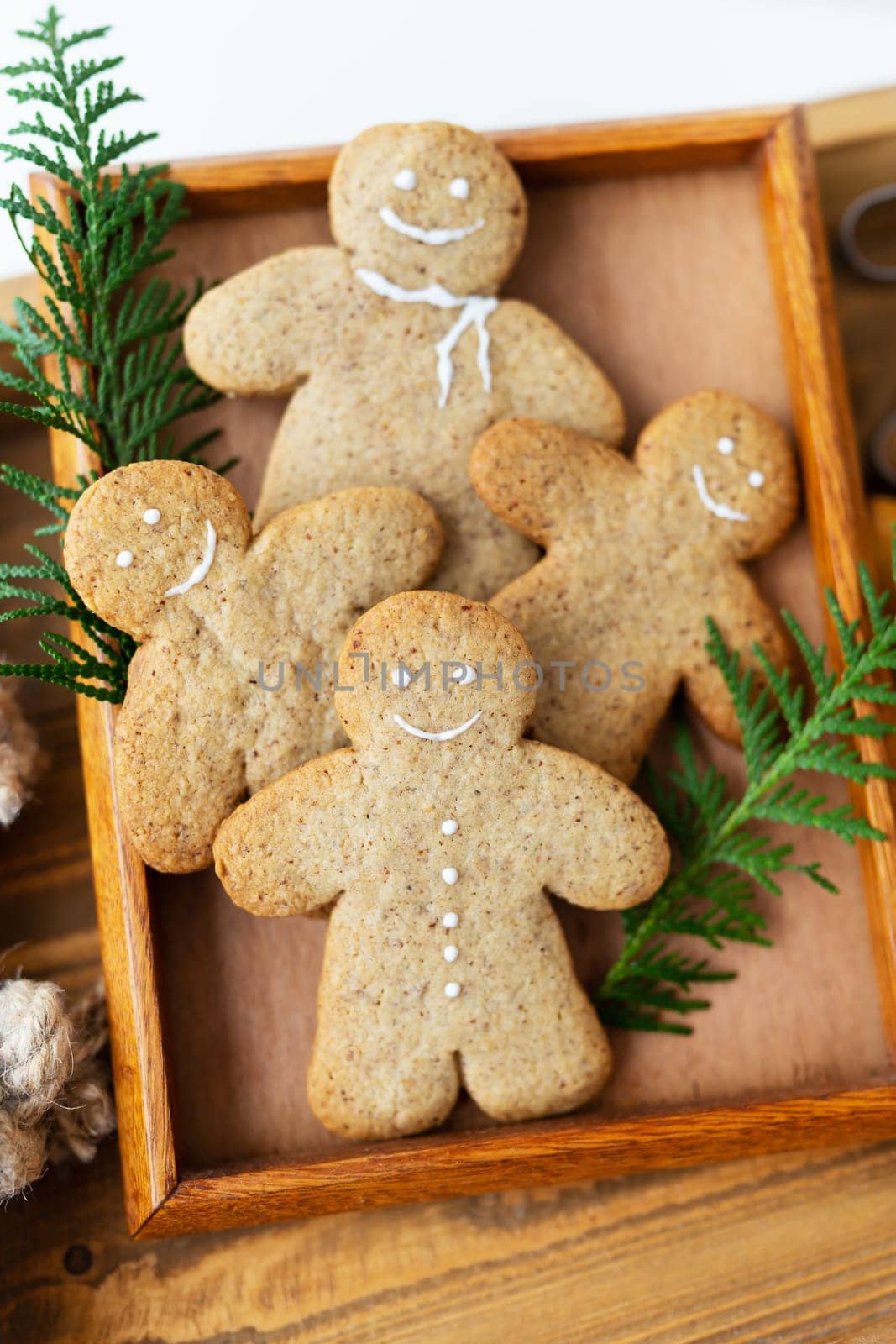 Gingerbread Man. Cooking gingerbread cookies at home lies on a wooden tray. The concept of the holiday of Christmas and New Year