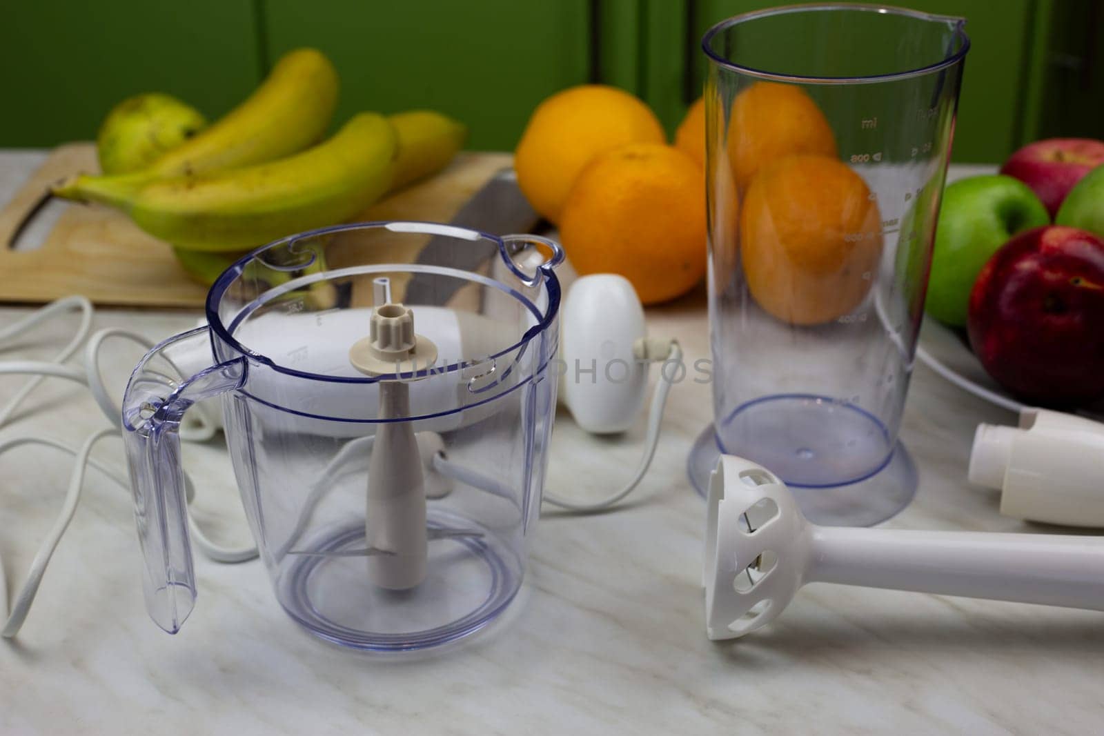 Disassembled blender and fruits on the table for making tasty drink with vitamins. Strengthening health with fruits and sports cocktails. Making smoothies in blender
