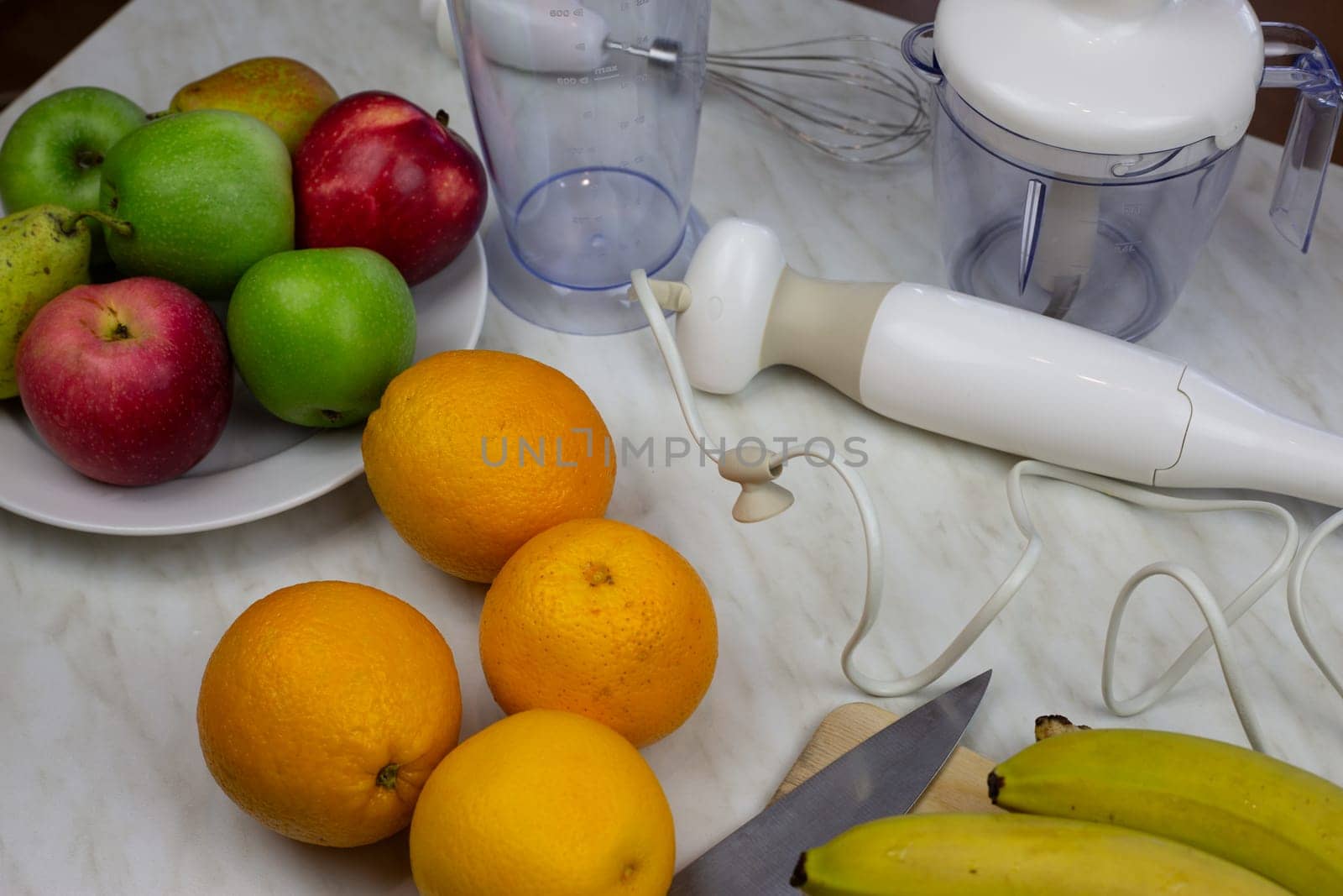 Table with fruits and blender for making smoothies and sports drinks. Ingredients for healthy fruit cocktail for health and immunity at home