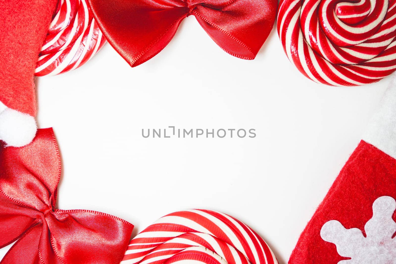 Flatlay of some red Christmas decoration, on a white background. Background for Christmas.