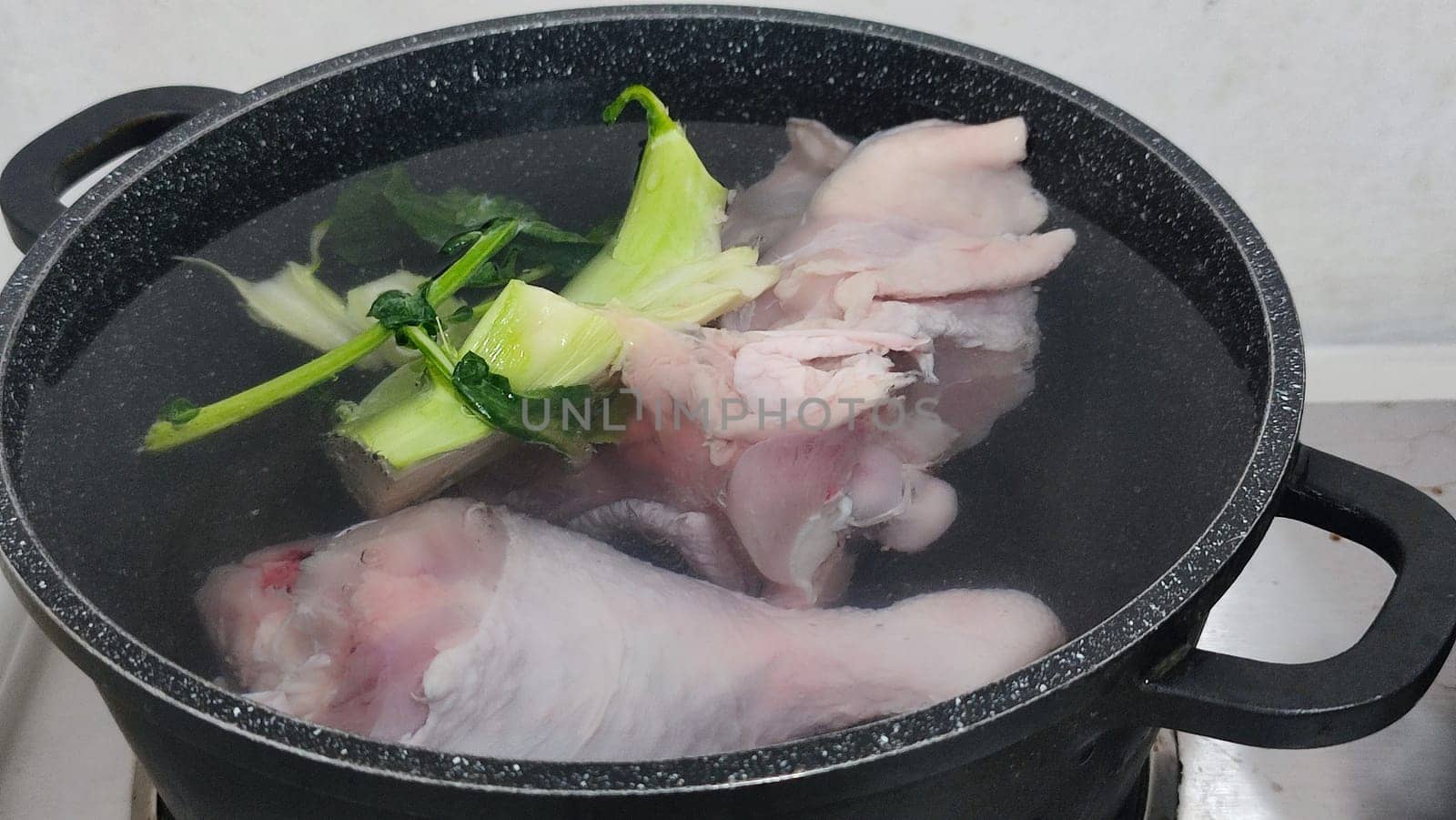 chicken leg in a saucepan for broth, food lunch cooking preparation dinner, products. High quality photo