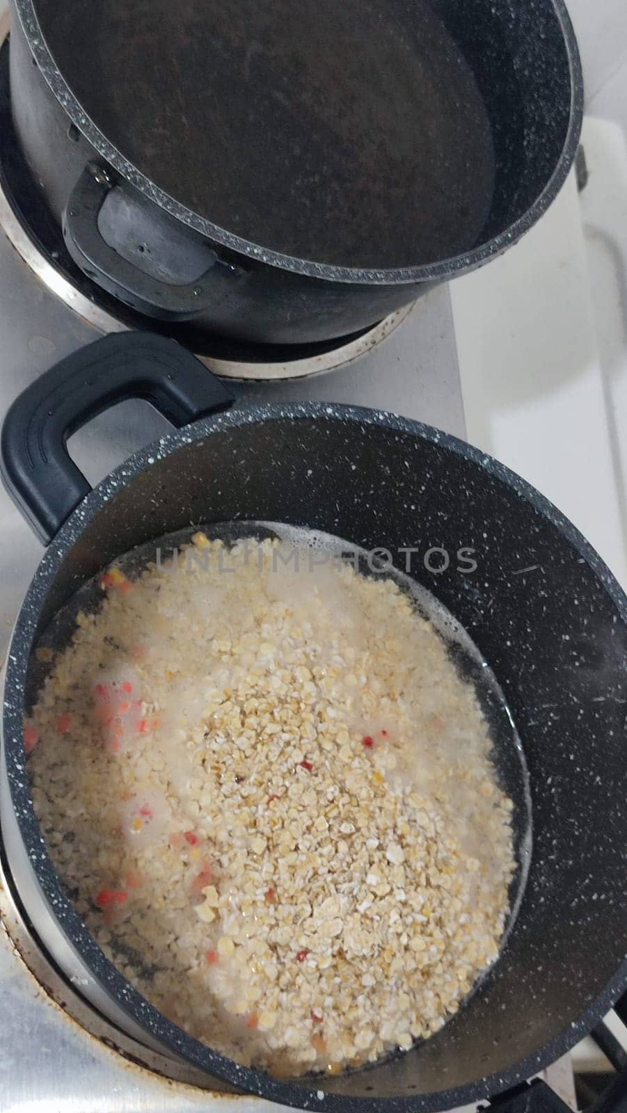 oatmeal porridge in a saucepan, healthy food on the stove, cooking lunch dinner breakfast. High quality photo