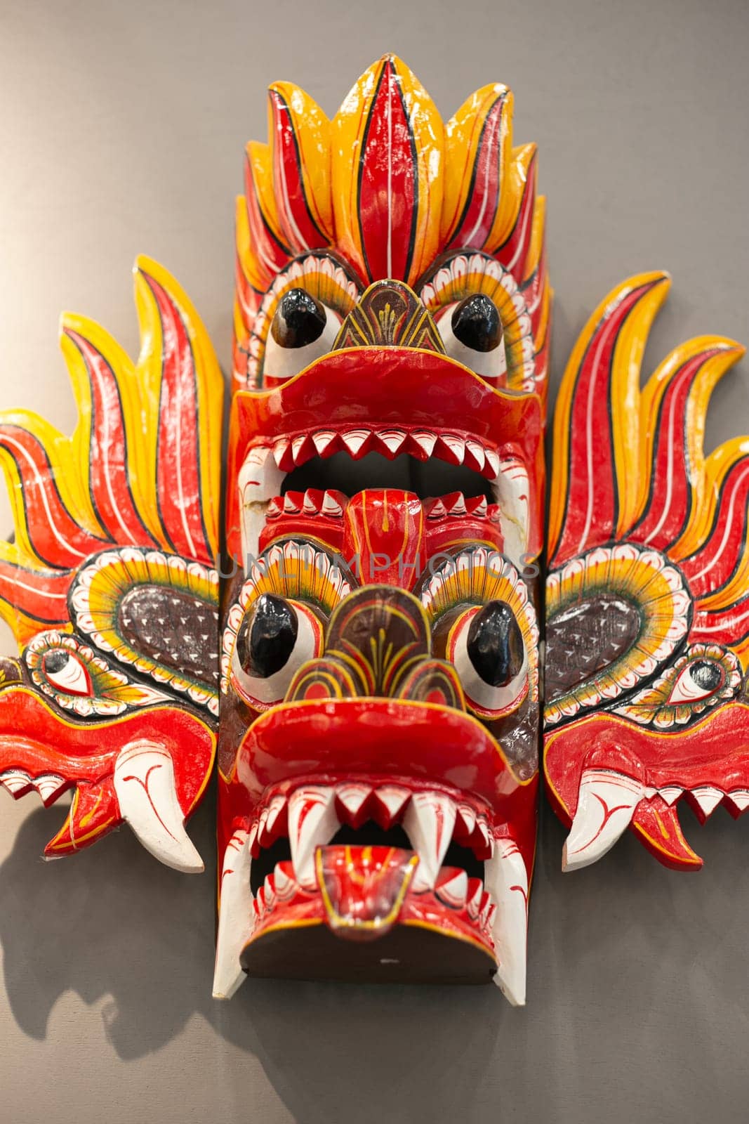 A religious mask painted from wood. With fangs. Scary.