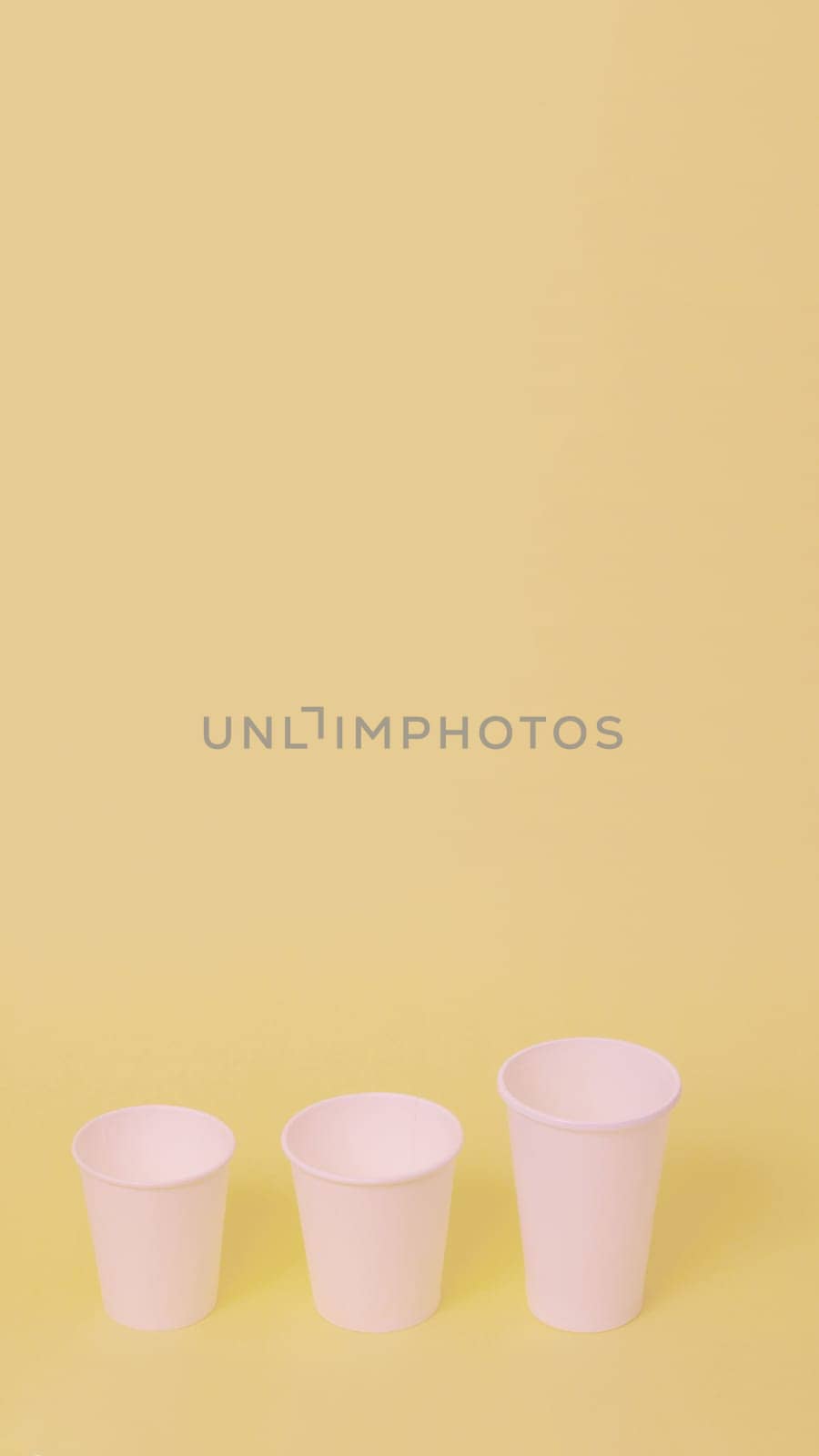 Take away a cup of coffee on orange paper background.