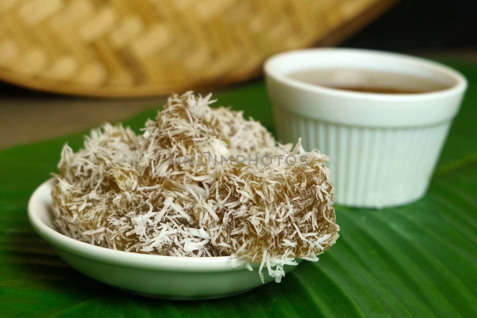 Kue Ongol-ongol is a traditional Indonesian snack made from tapioca flour and coconut milk, steamed in a banana leaf and served with brown sugar syrup. It has a chewy texture and a sweet, nutty flavor.