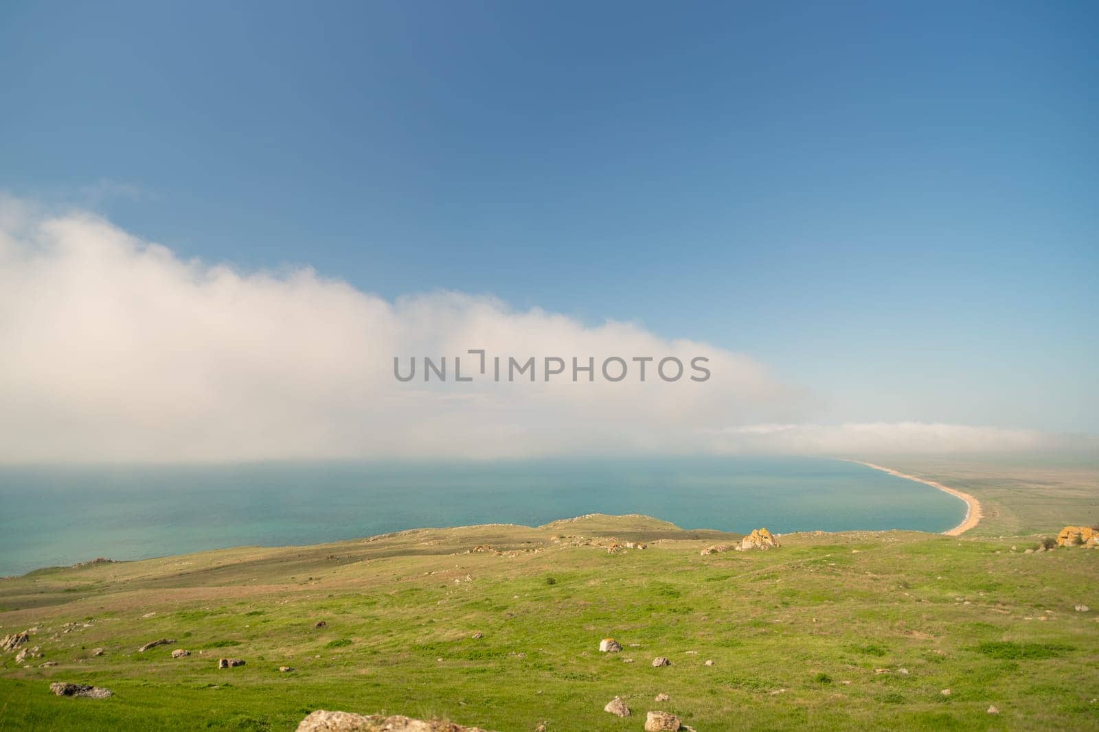A beautiful blue ocean with a cloudy sky in the background