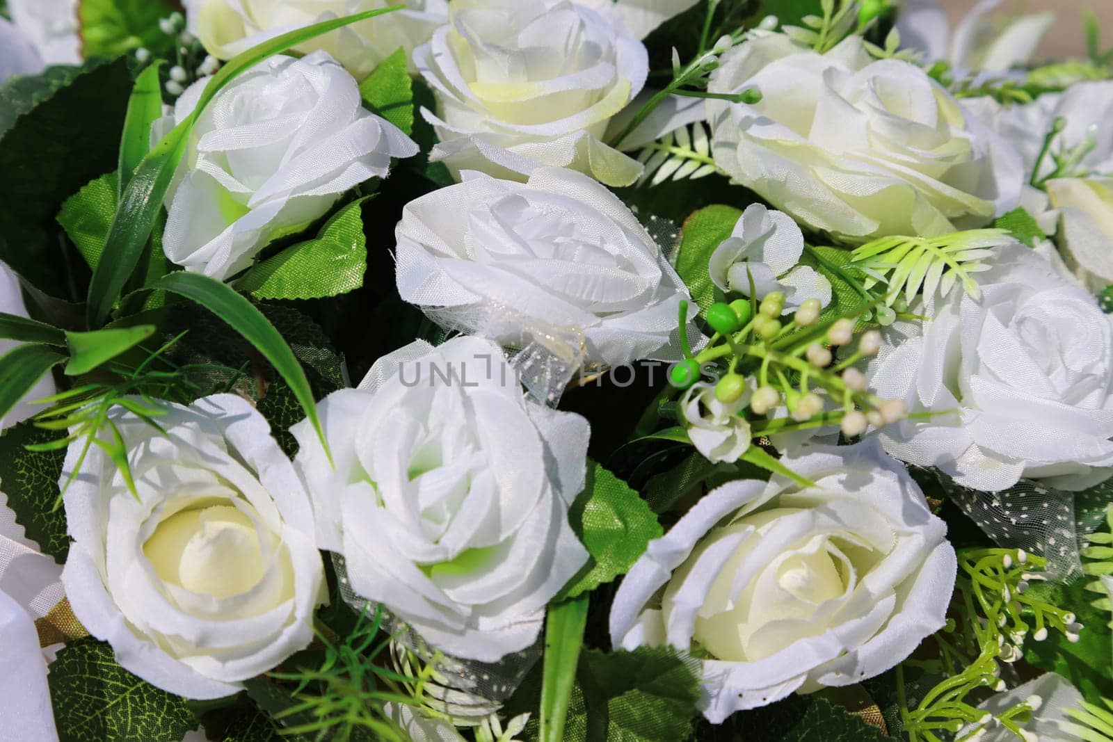 White roses in a decorated bouquet close-up. Wedding decorations.