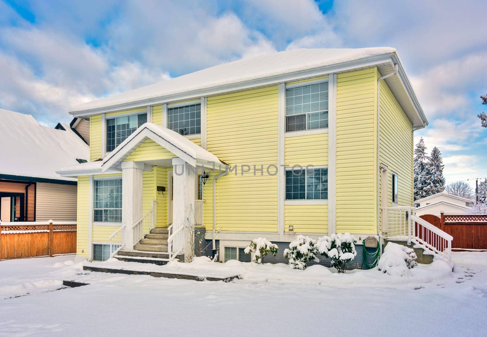 Yellow residential house on winter season in Vancouver, Canada.