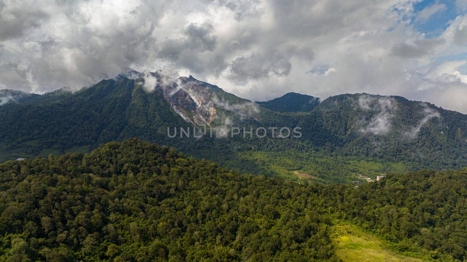 Active Sibayak volcano and mountains with forest. Sumatra, Indonesia.