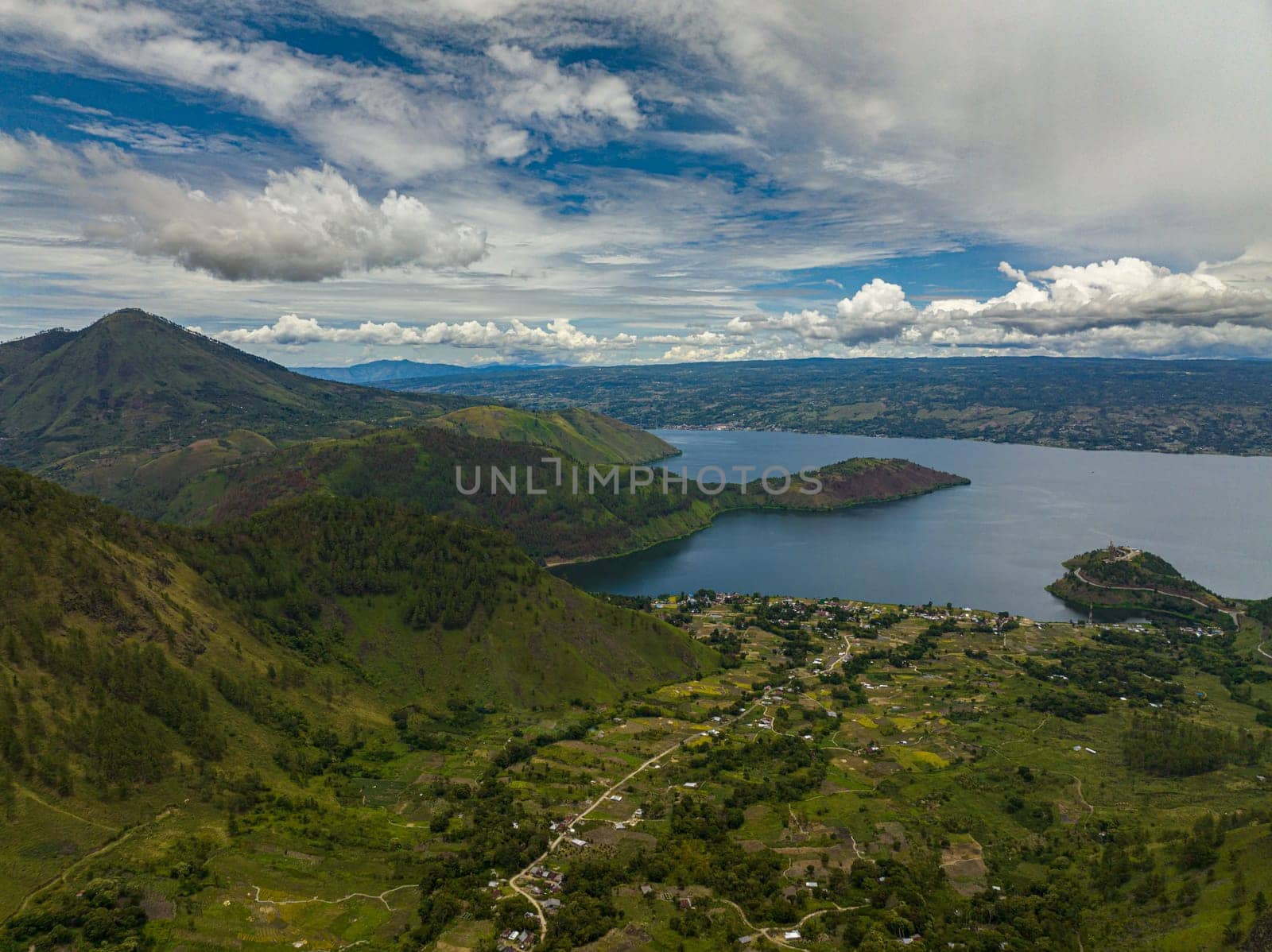 Aerial view of mountains with forest and Lake Toba. Samosir Island. Sumatra, Indonesia.