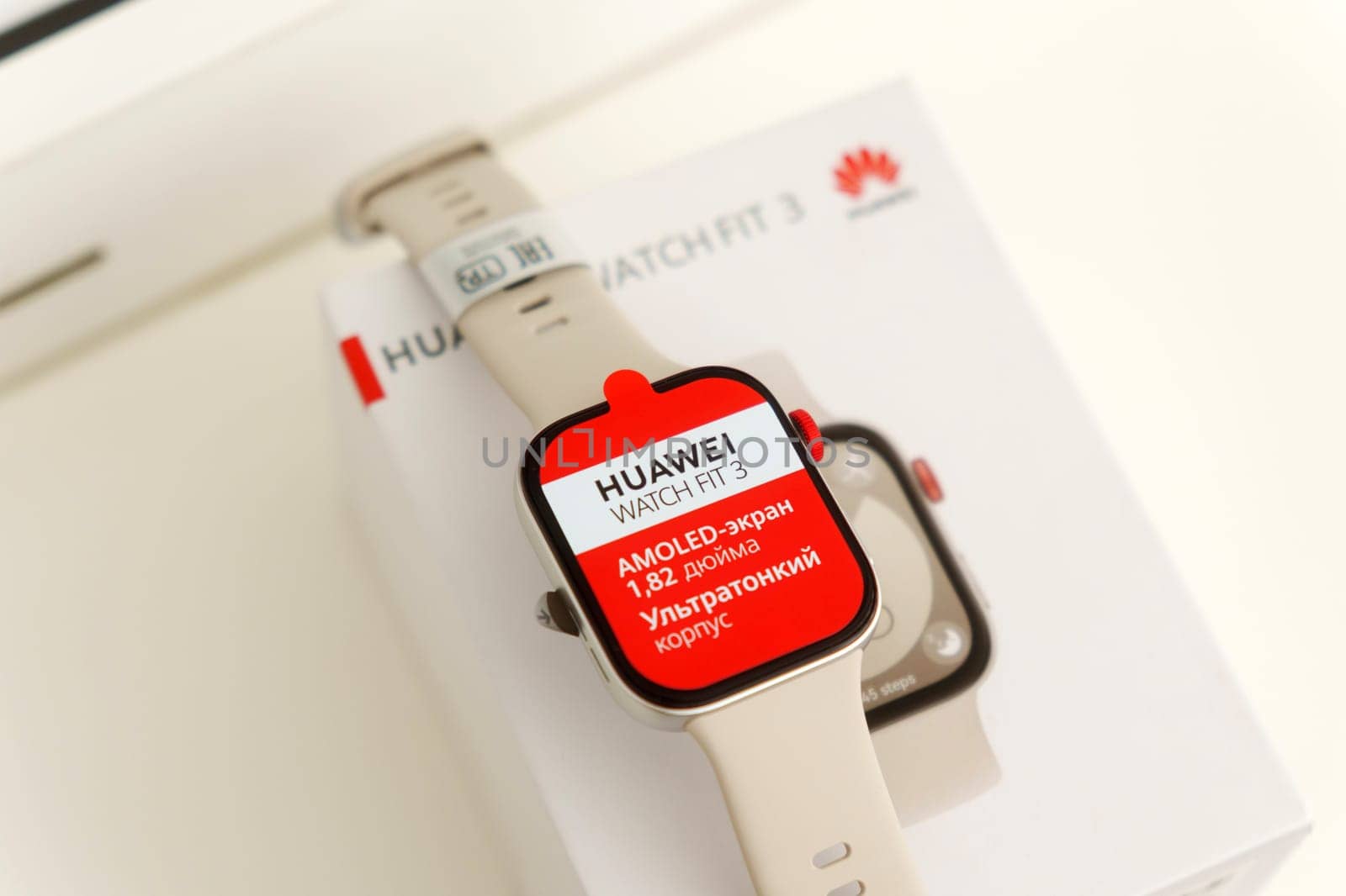 Tyumen, Russia-June 20, 2024: Huawei Watch Fit 3 with a red screen displaying the text AMOLED