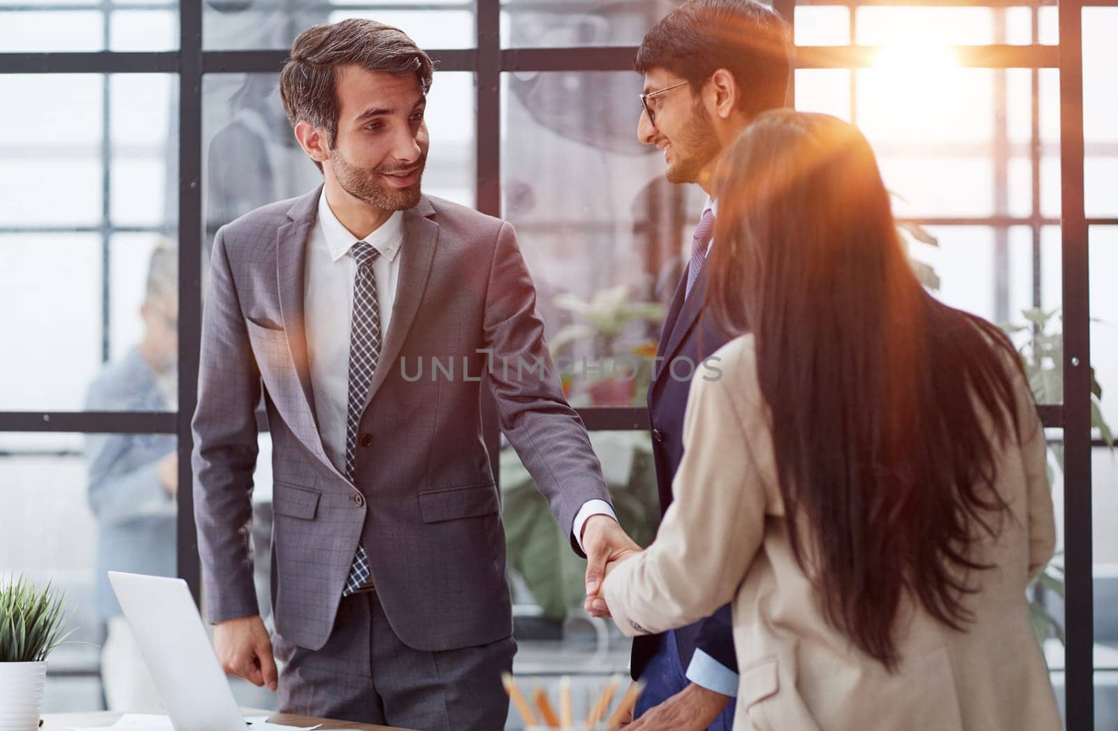 Euphoric excited business team celebrate corporate victory together in office