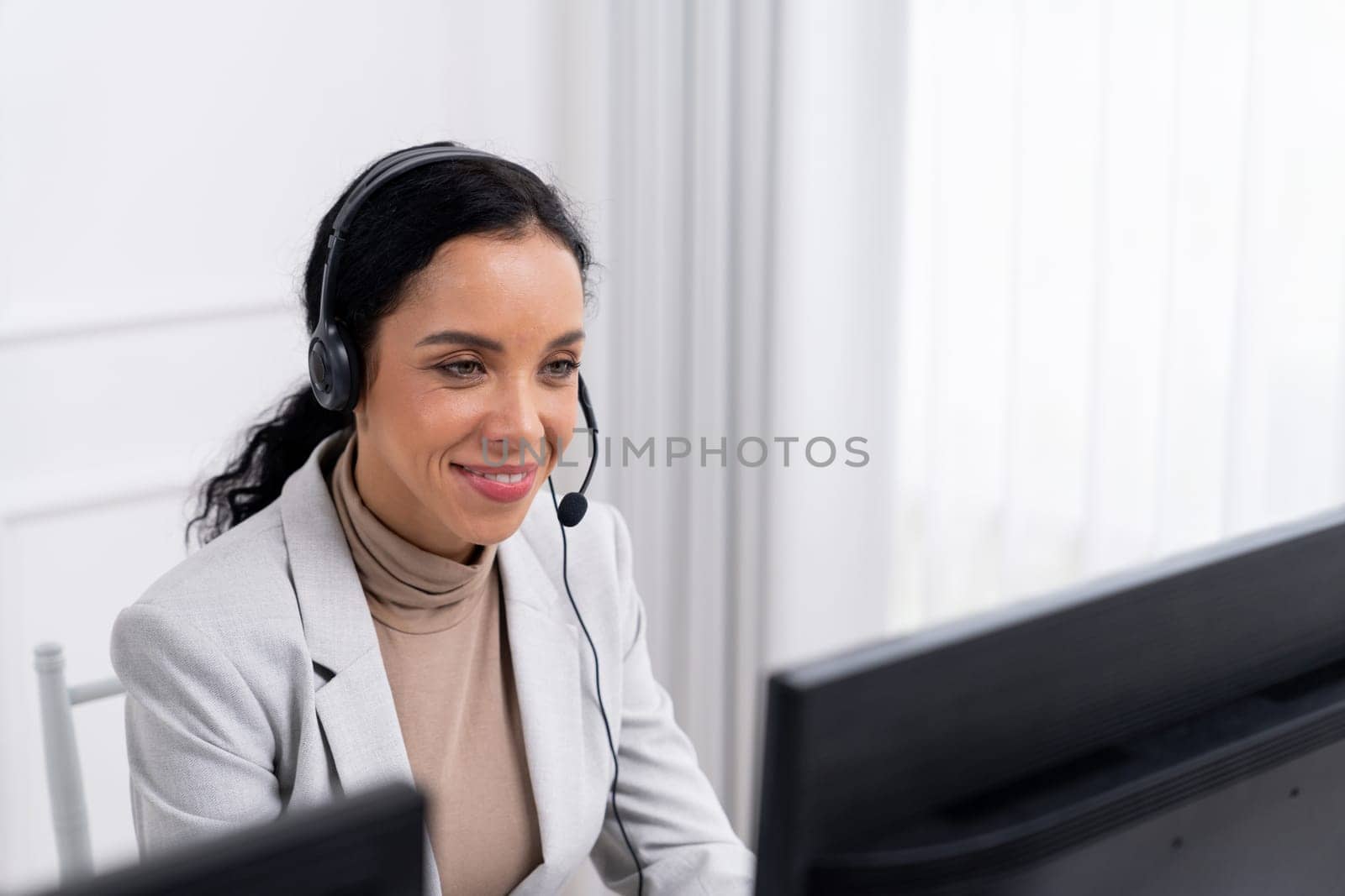 African American young businesswoman wearing headset working in office to support remote crucial customer or colleague. Call center, telemarketing, customer support agent provide service on video call