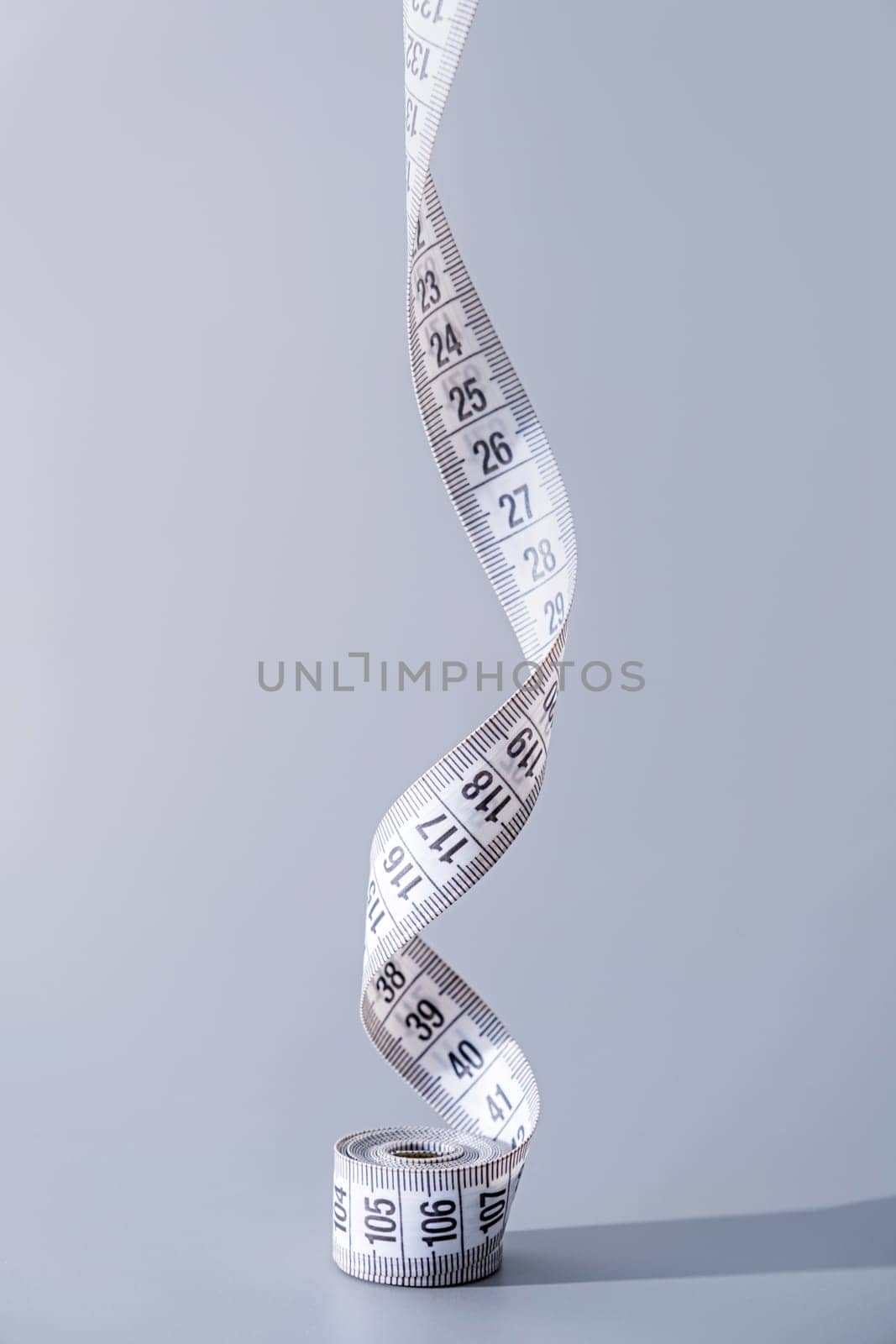 colorful measuring tapes front view on gray background by Desperada