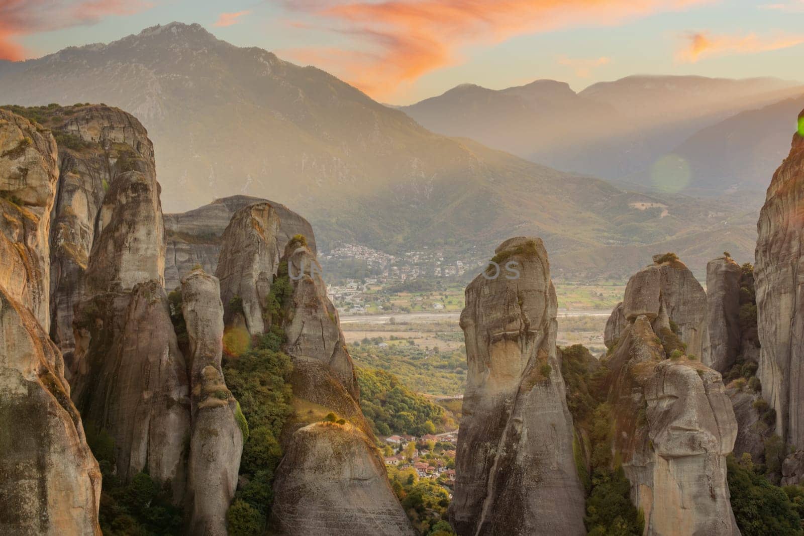 Greece. Sunny summer evening in the mountains of Thessaly. Majestic rocky mountains. Sunset clouds over the mountain ranges